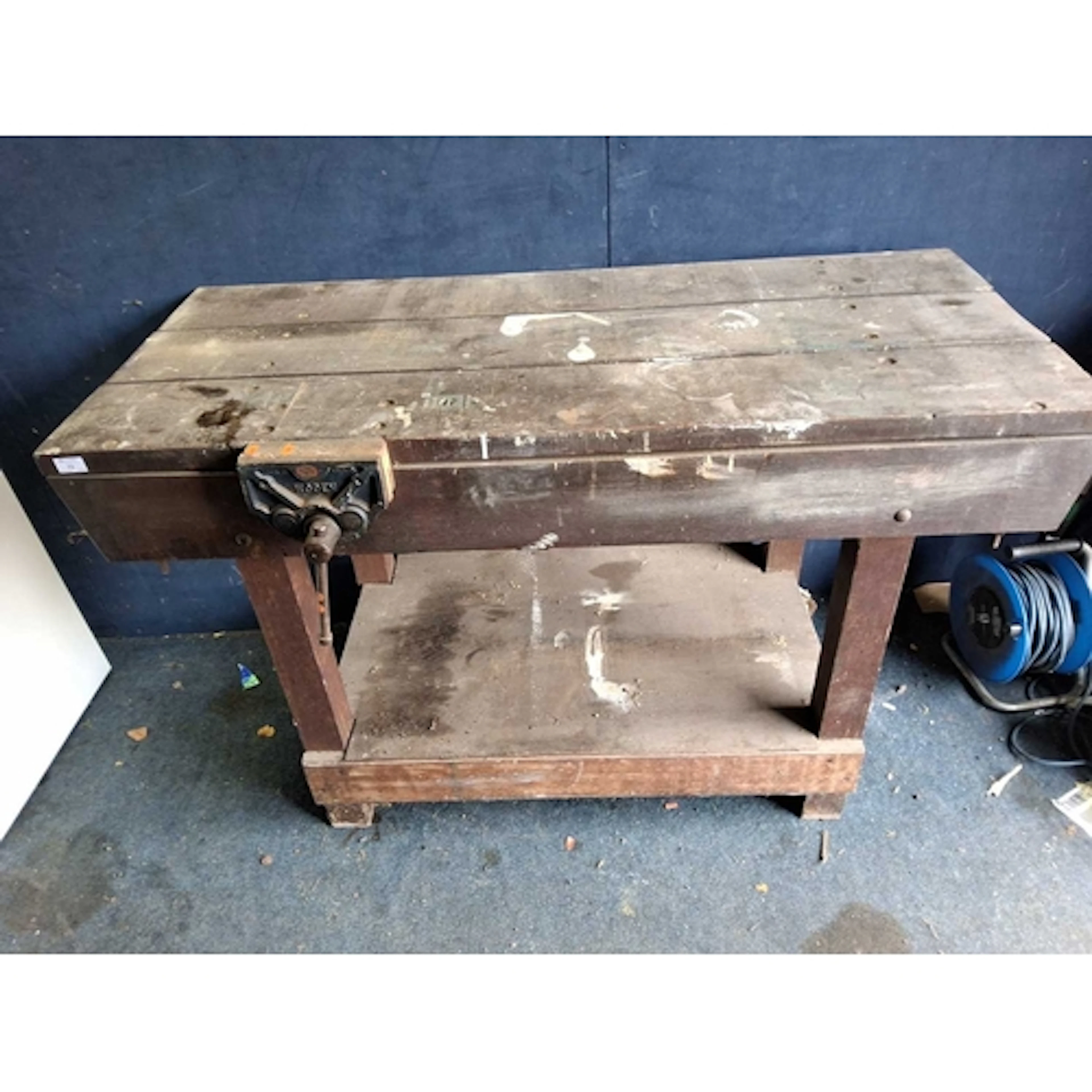 A HARDWOOD WORKBENCH fitted with a Woden vice and undershelf...