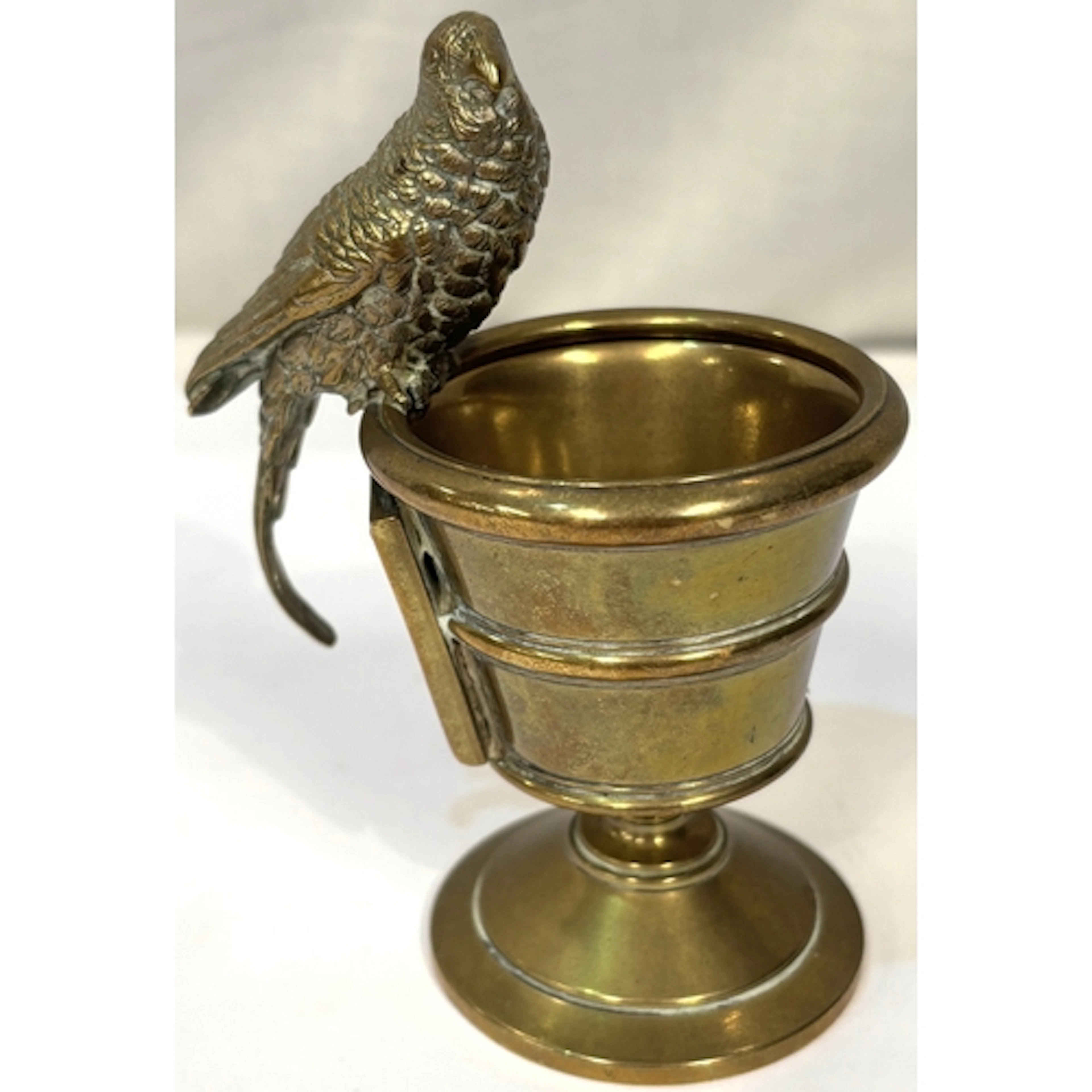 A Victorian brass urn shaped match strike with cockateel, 10...