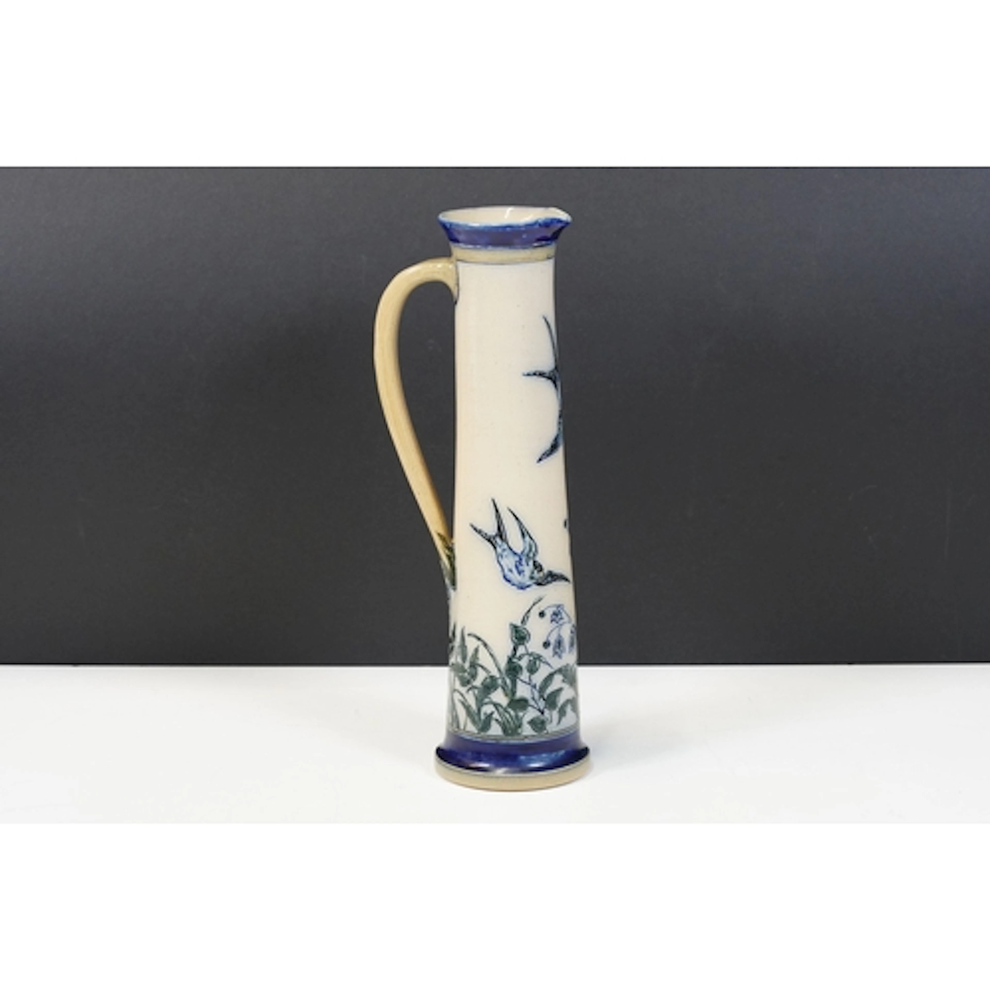 Martin Brothers jug of tall narrow tapering form, incised de...