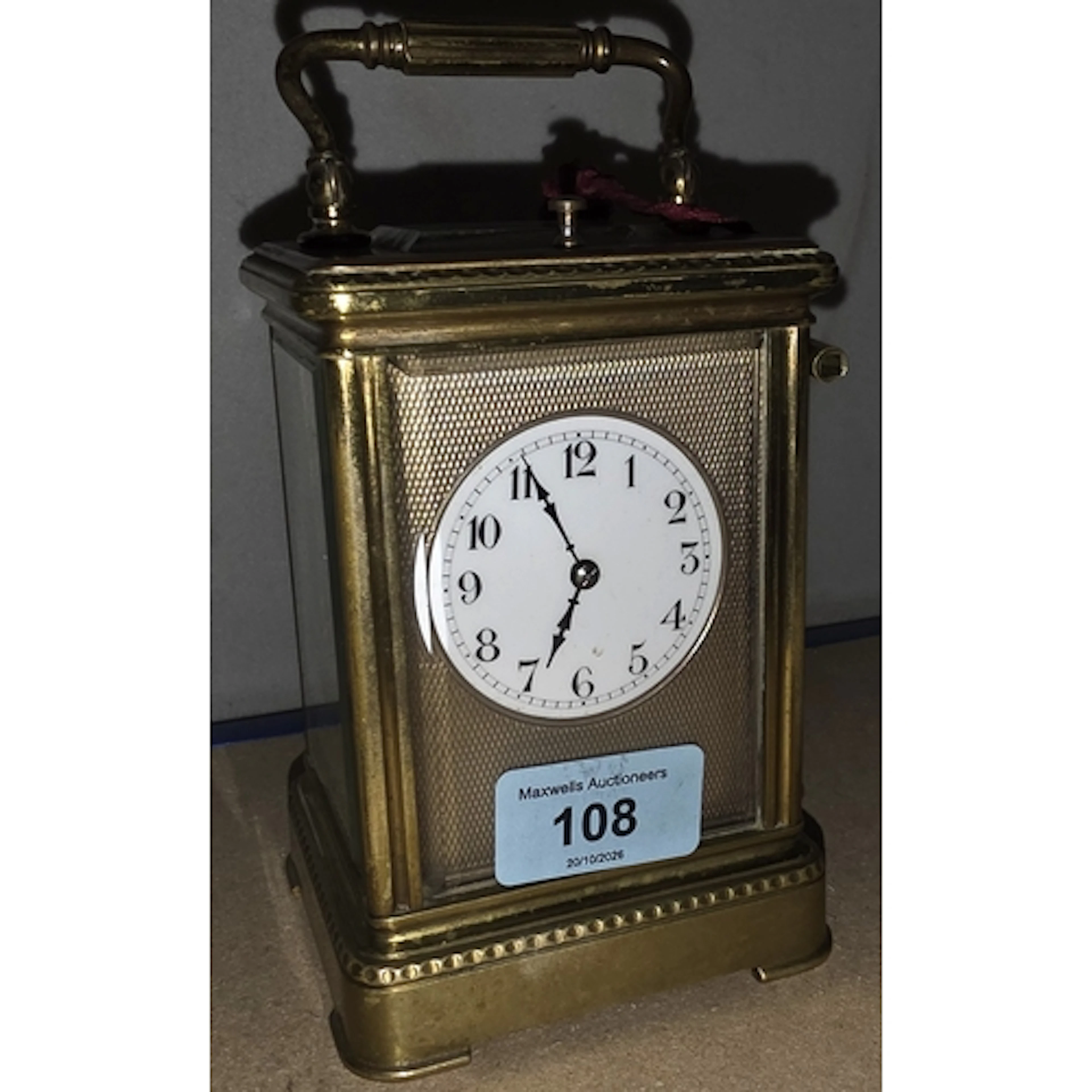 A 19th century French brass cariage clock white enamel dials...
