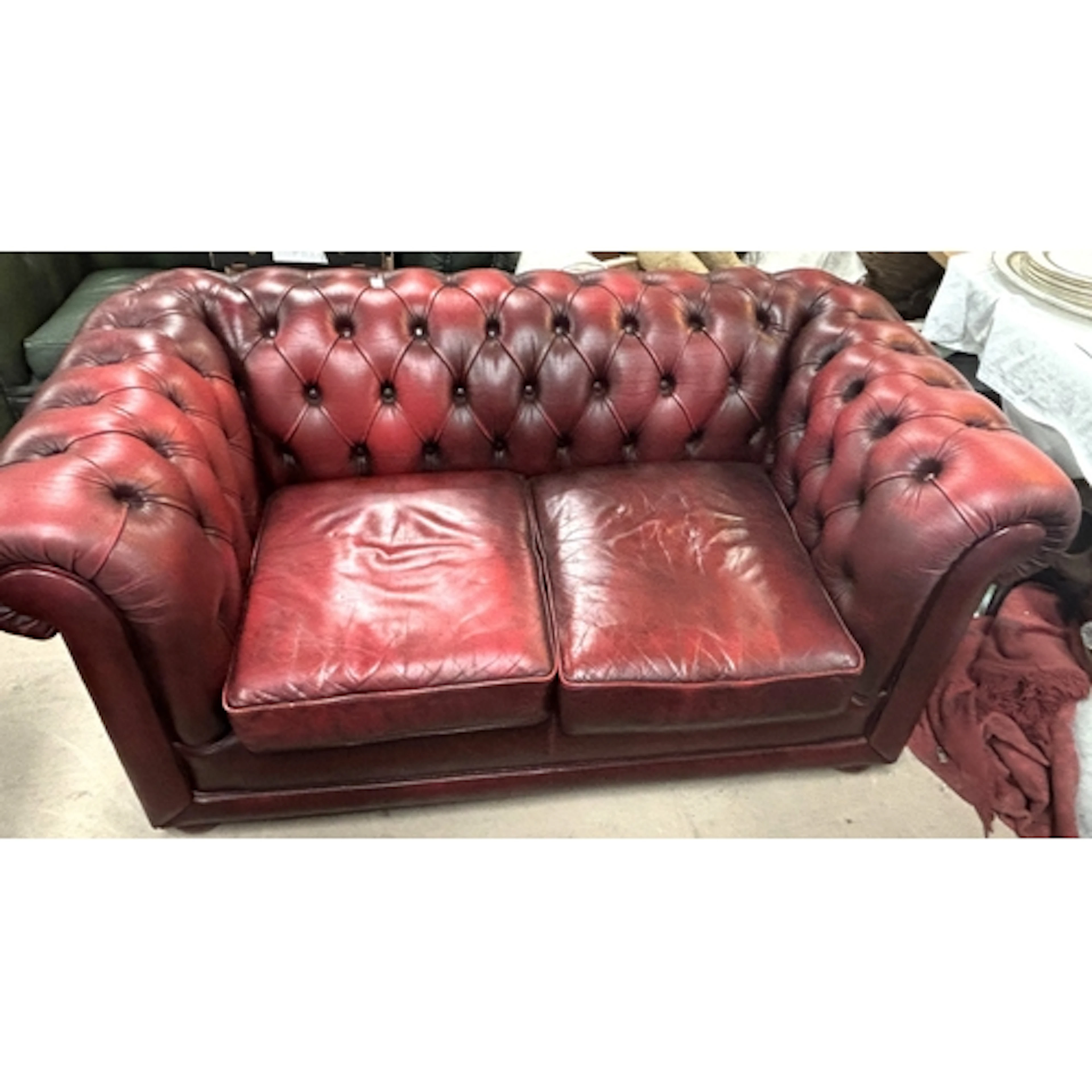 A deeply buttoned 2 seater Chesterfield settee in "antique" ...