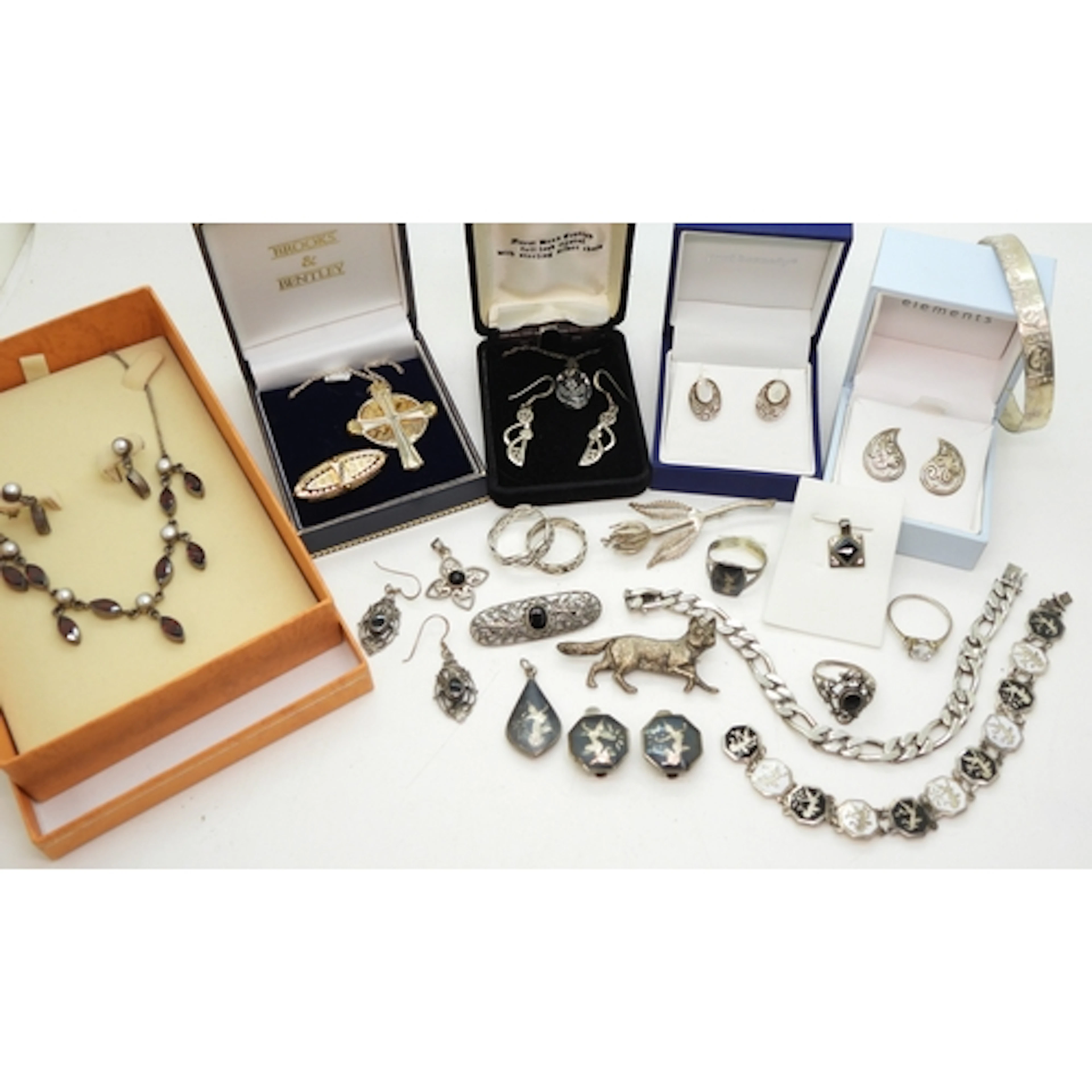 A silver Brooks & Bentley 'Footprints' pendant, a silver...