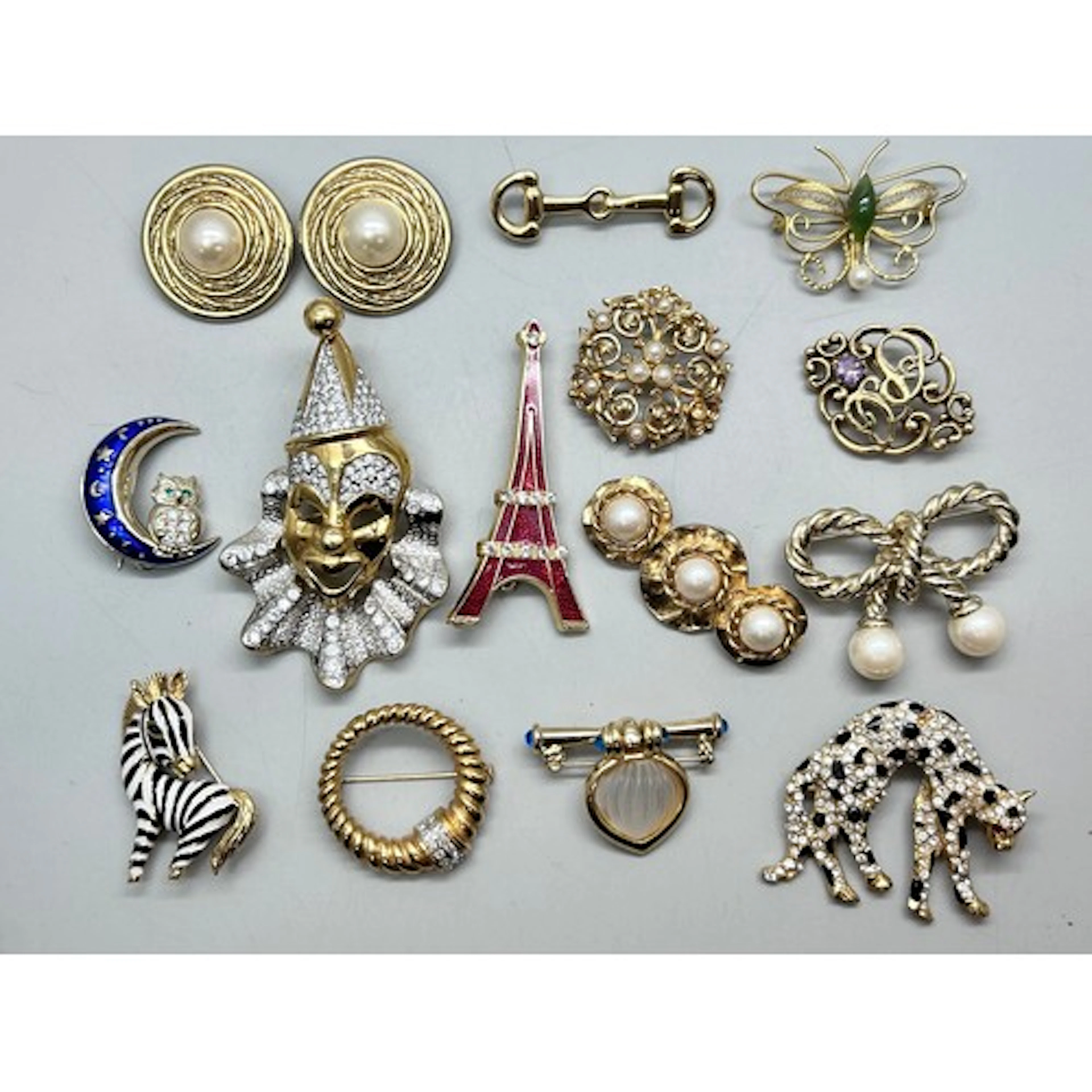 A collection of vintage gold tone costume brooches