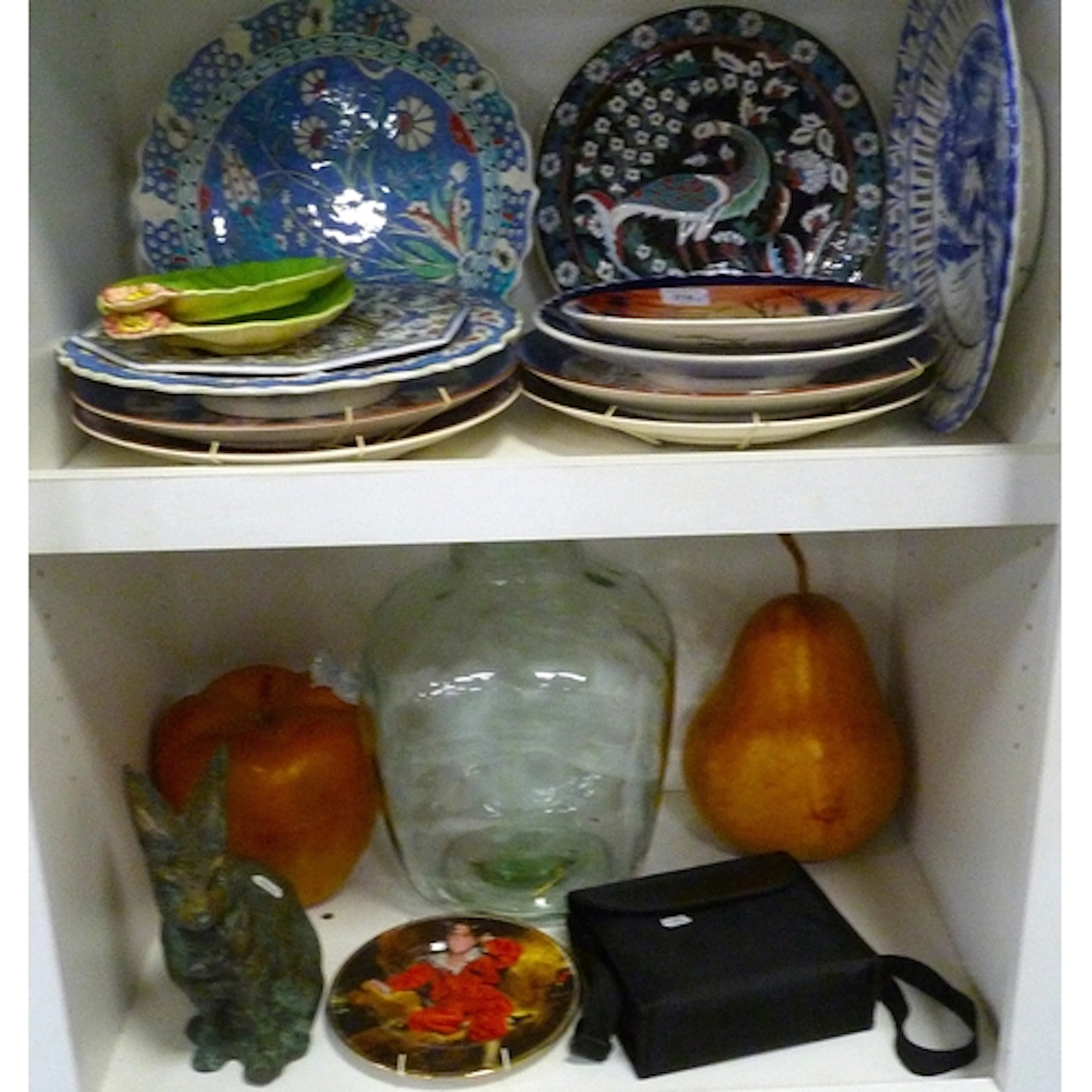Two shelves of ceramic plates and chargers in the Iznik, Chi...