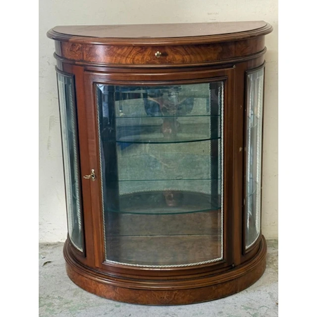 A walnut veneer Demi-lune glazed display cabinet.