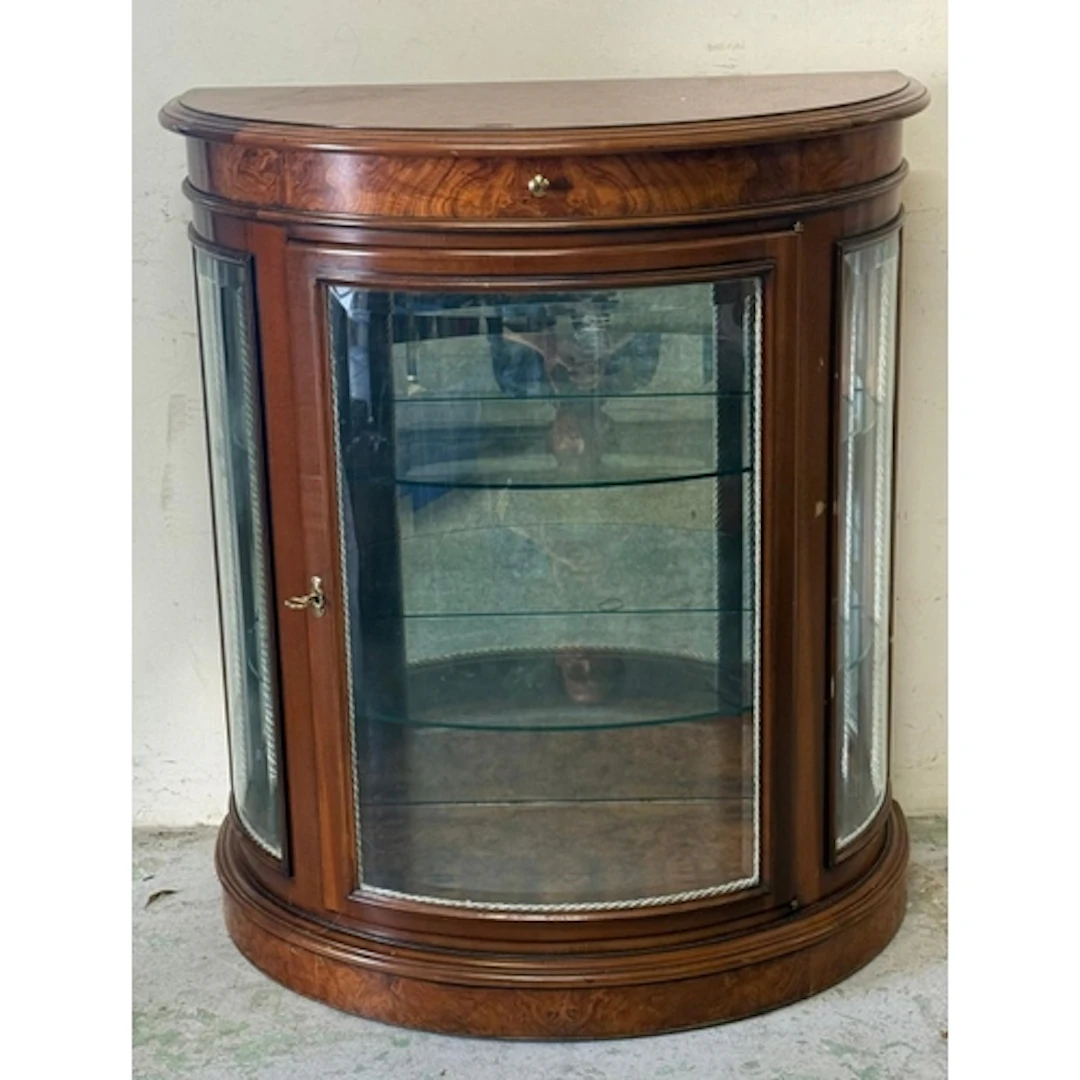 A walnut veneer Demi-lune glazed display cabinet.