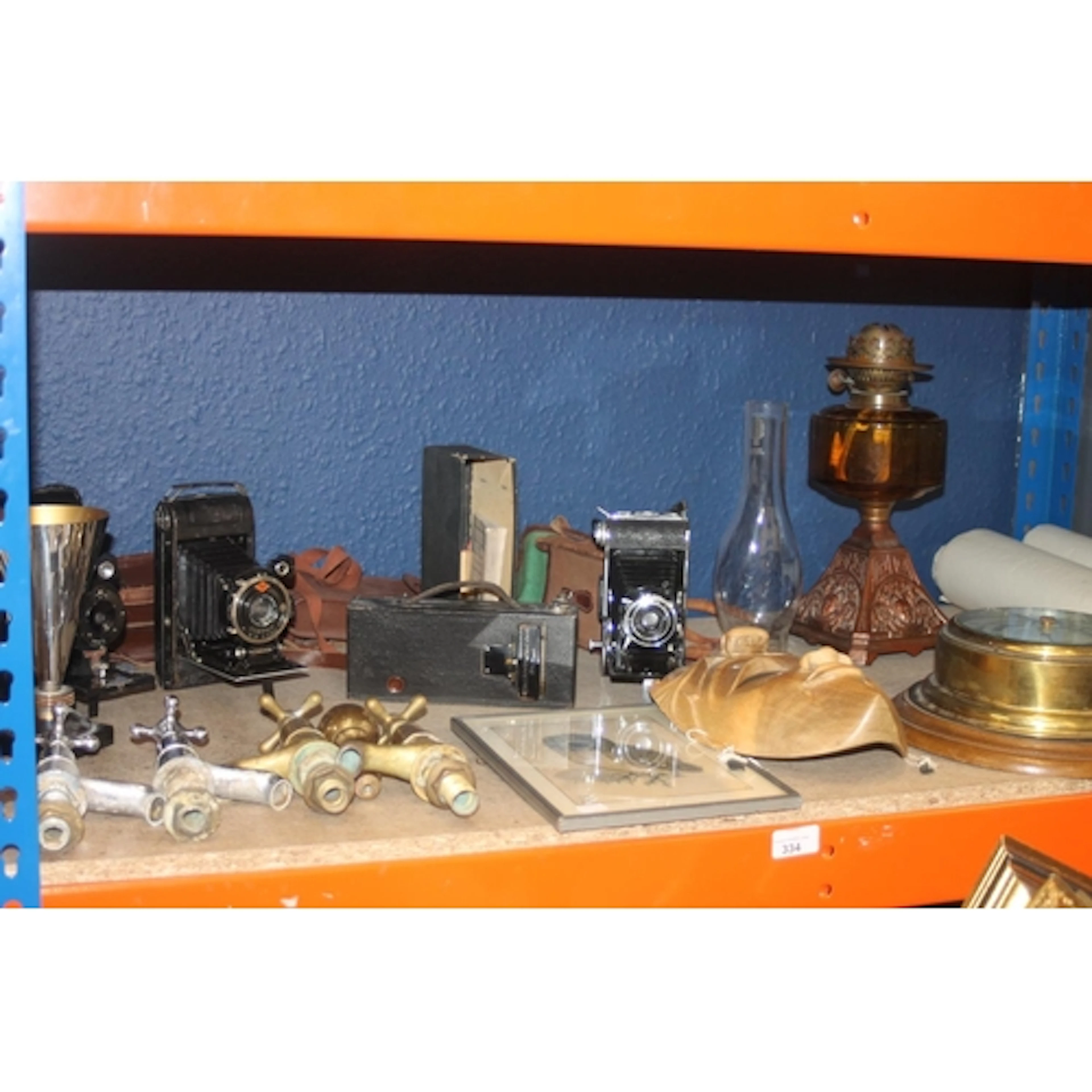 Shelf containing mixed items to include brass ships baromete...