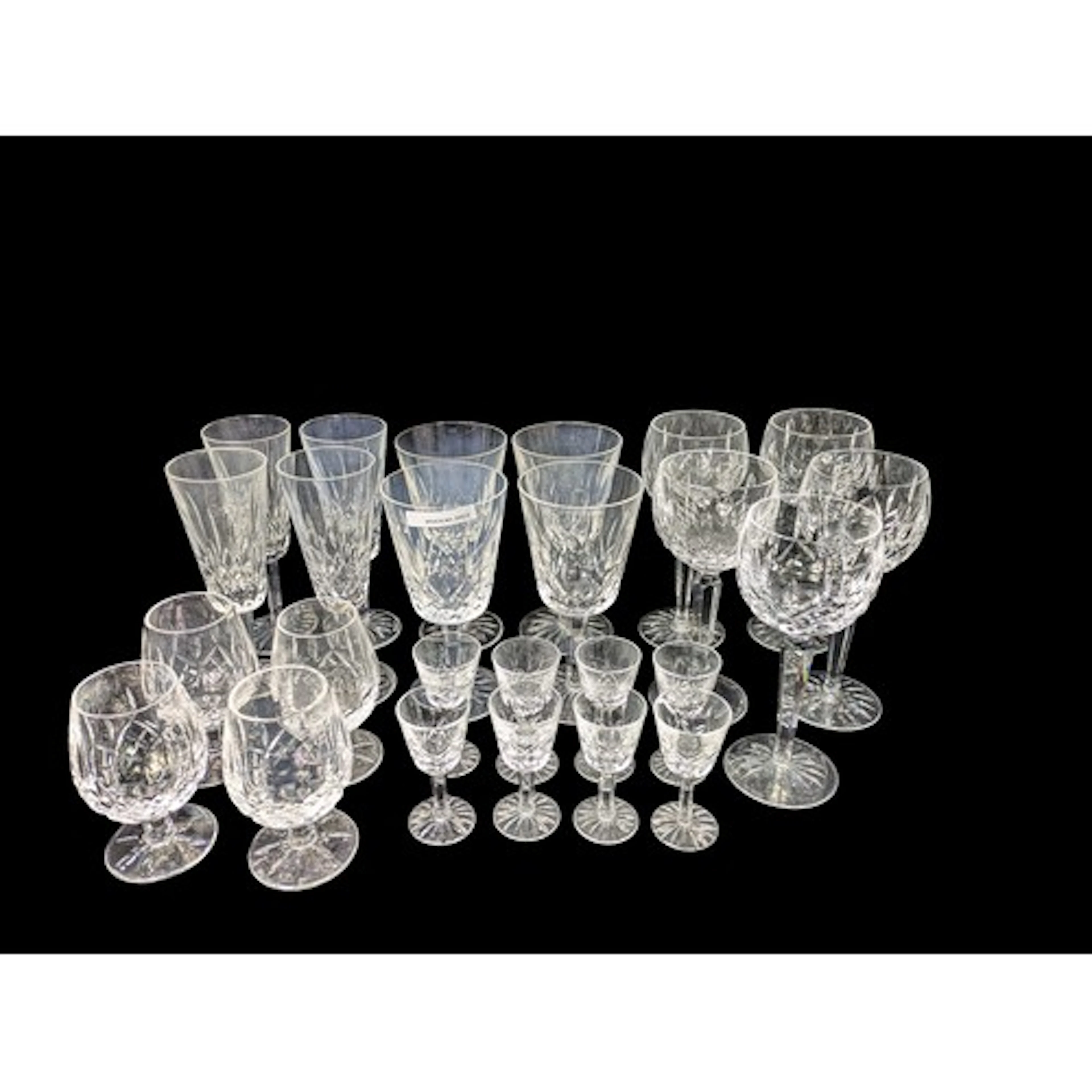 A collection of Waterford cut-glass stemware comprising roun...