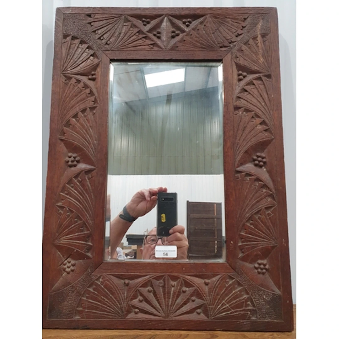 A carved oak framed Wall Mirror with bevelled plate and styl...