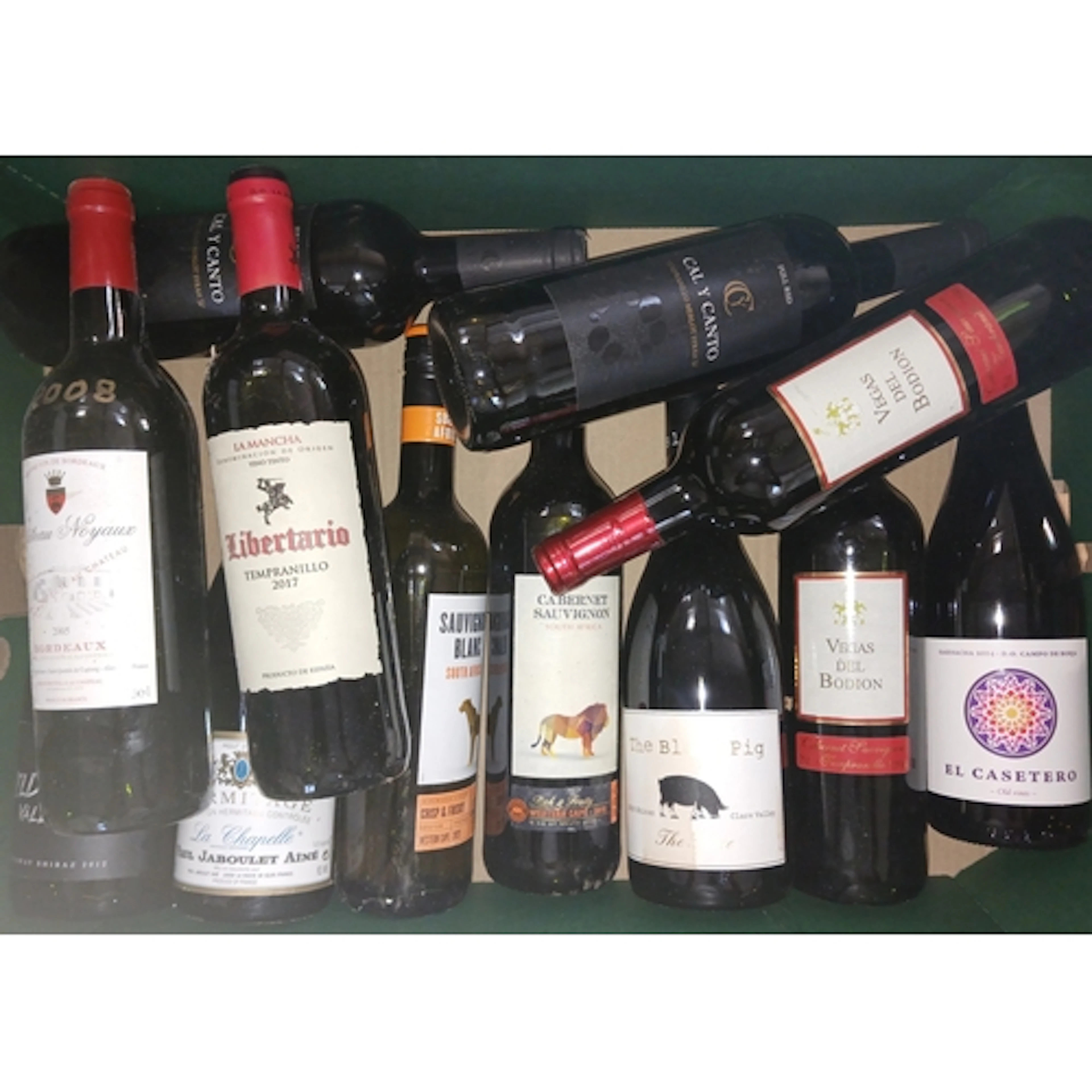 Four boxes of assorted red wines.