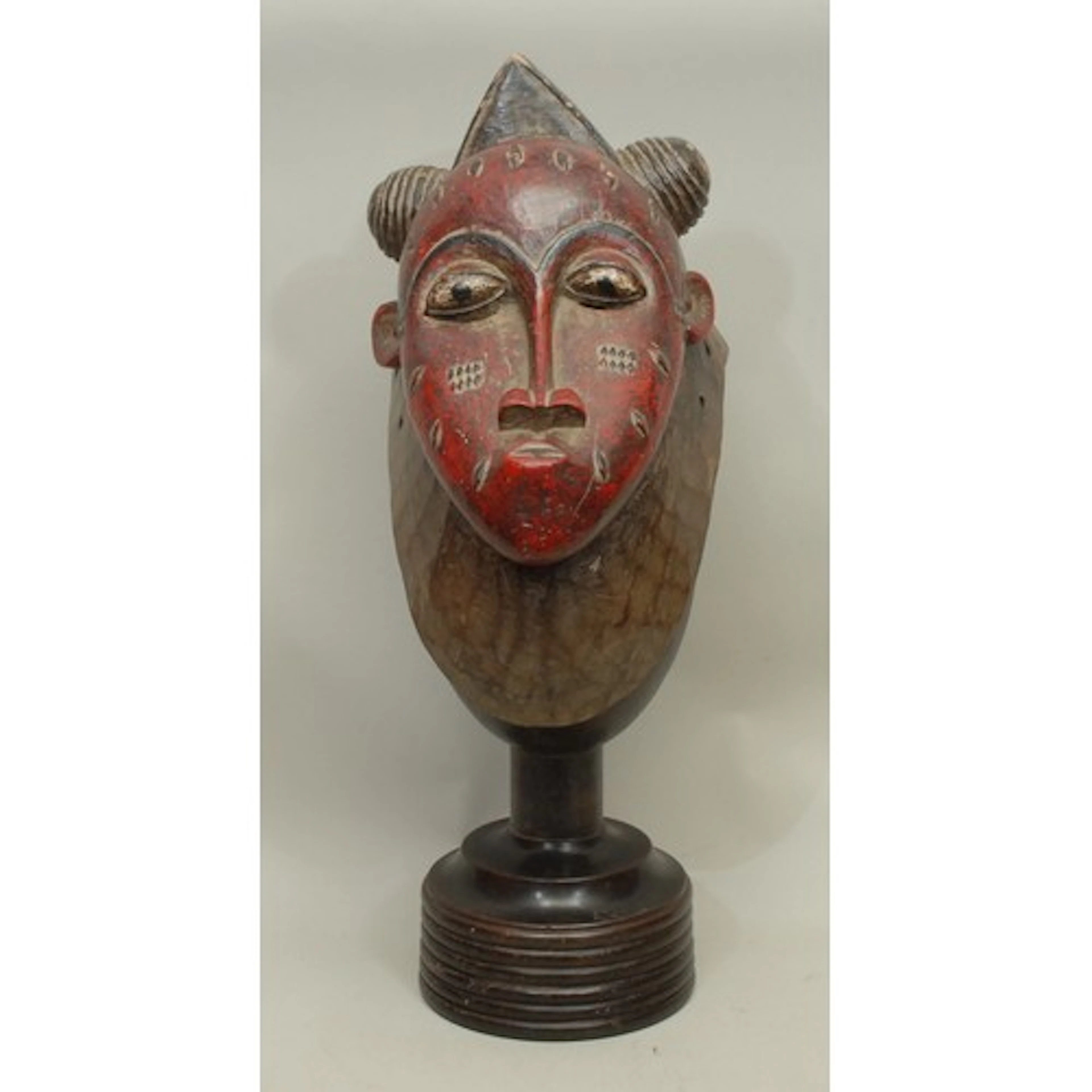 Tribal Art - a Baule painted softwood ceremonial mask, ellip...