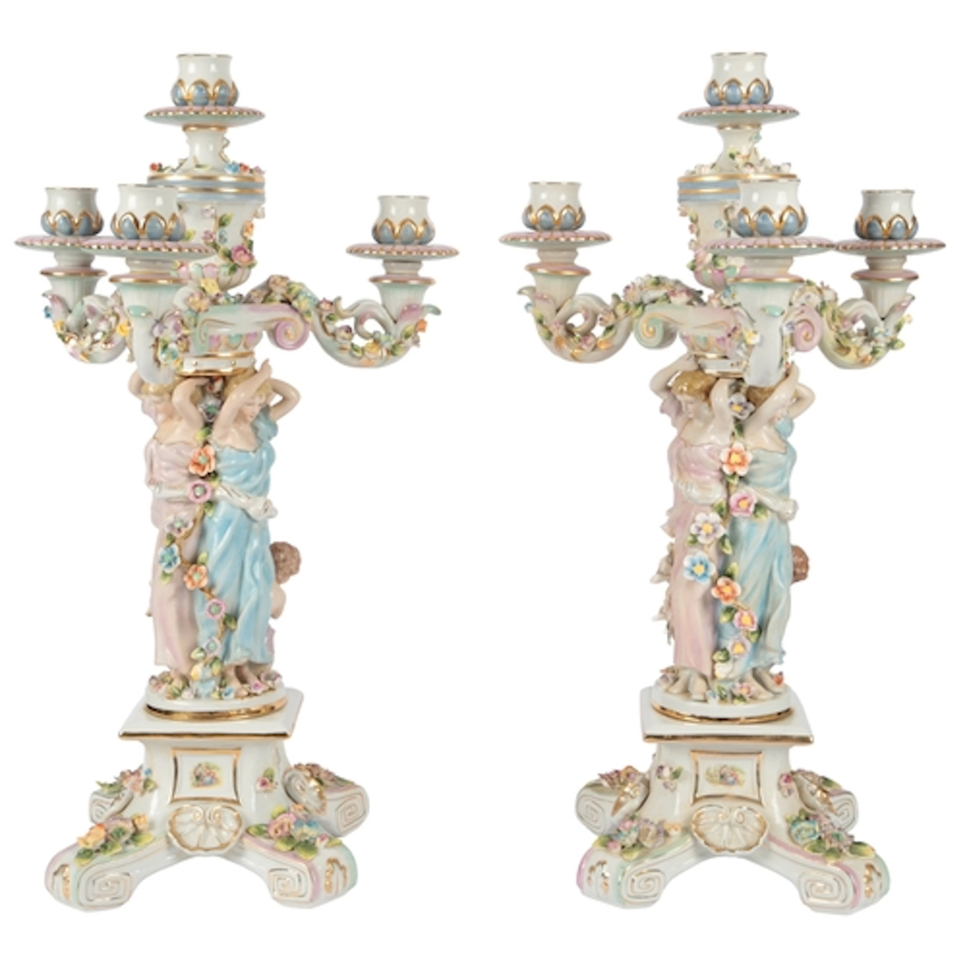 A pair of German porcelain three-branch figural candelabra, ...