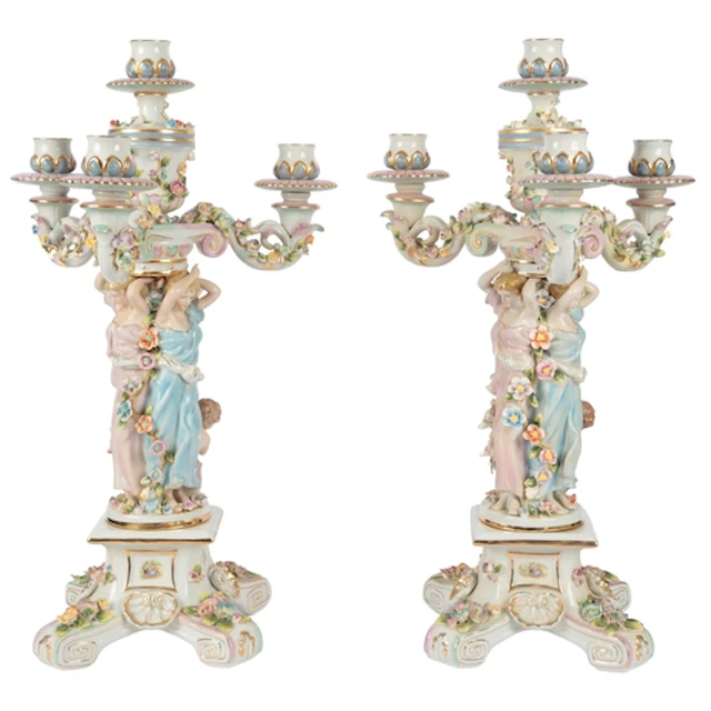 A pair of German porcelain three-branch figural candelabra, ...
