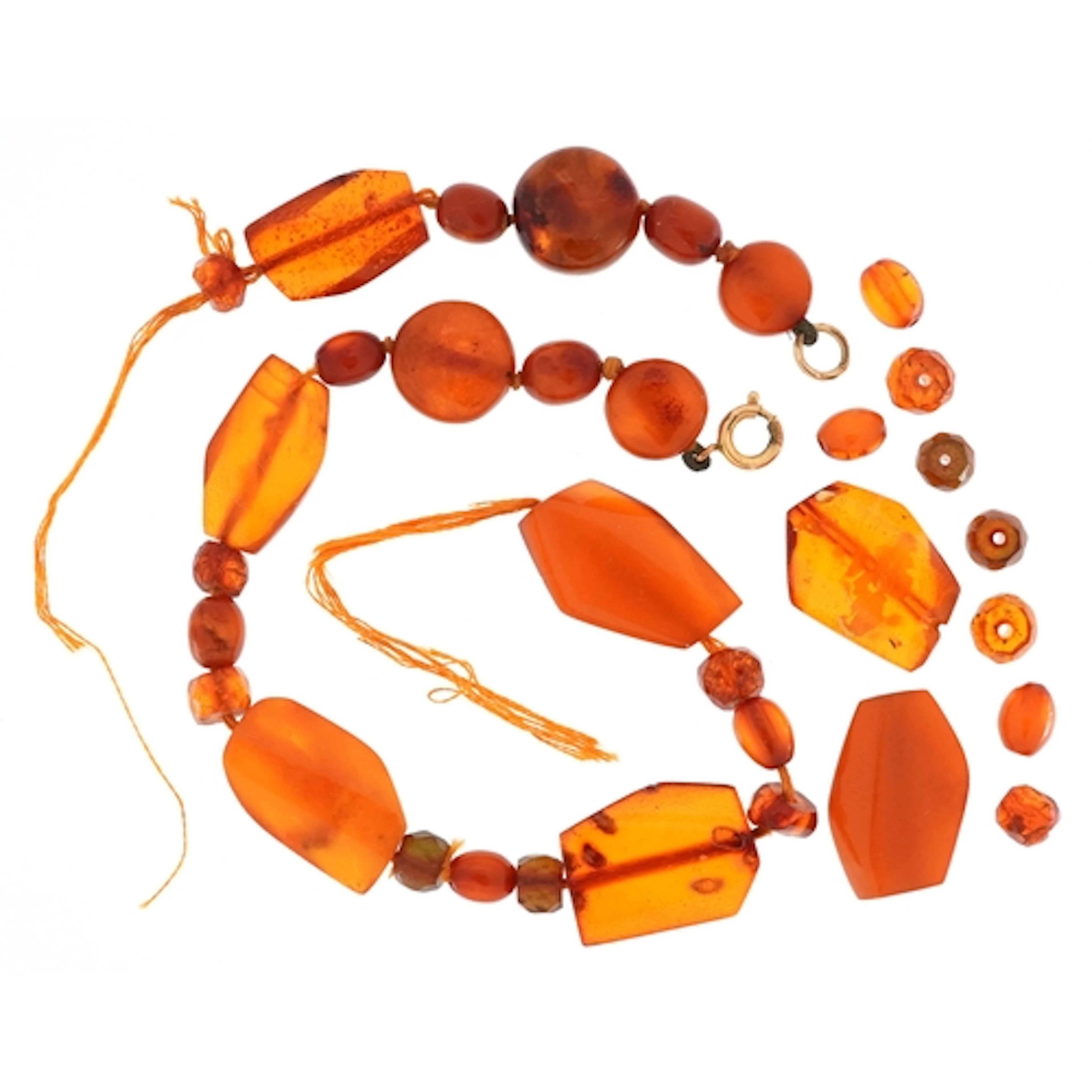 String of natural amber coloured beads, the largest approxim...
