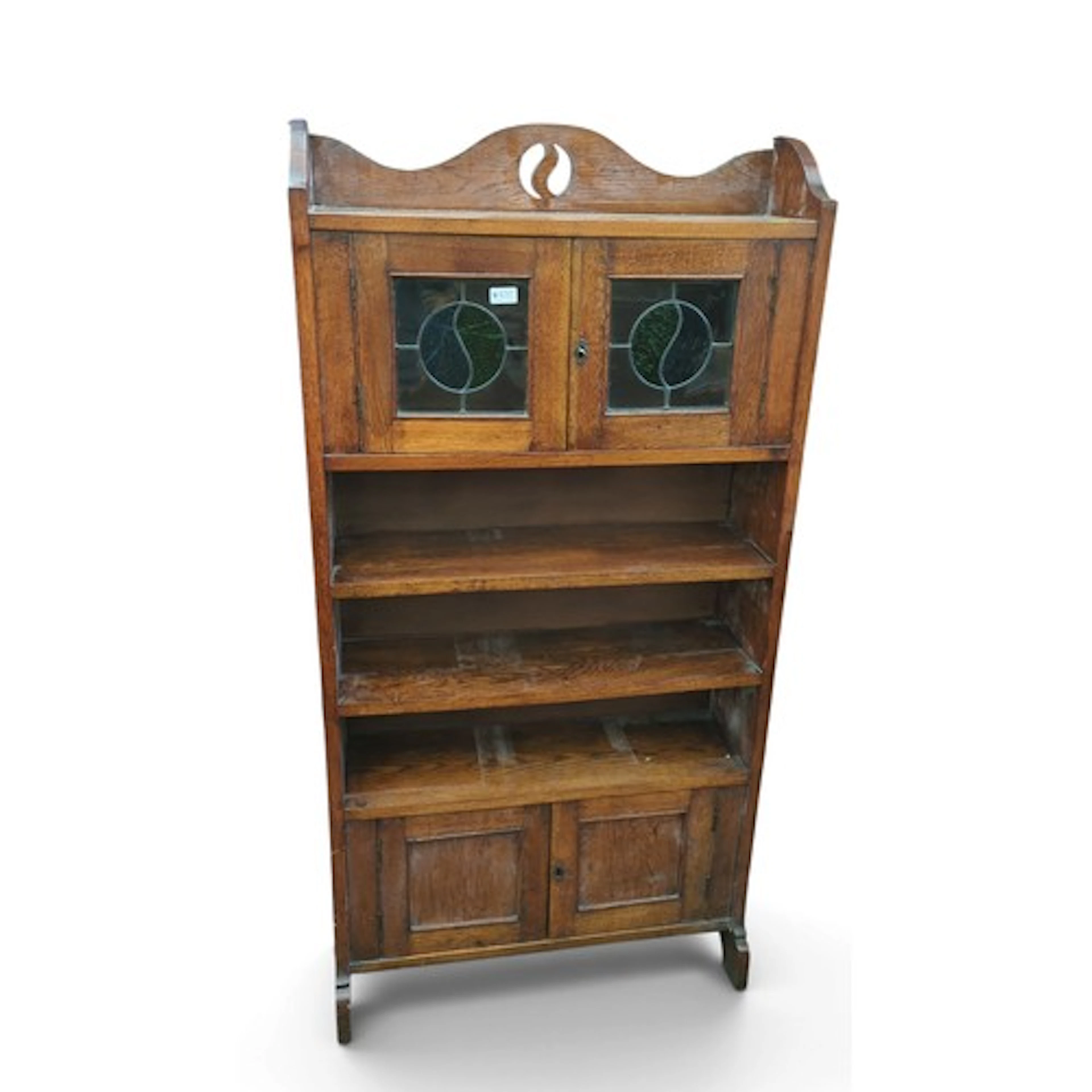 Arts and Crafts oak bookcase cabinet, circa 1900, with shape...