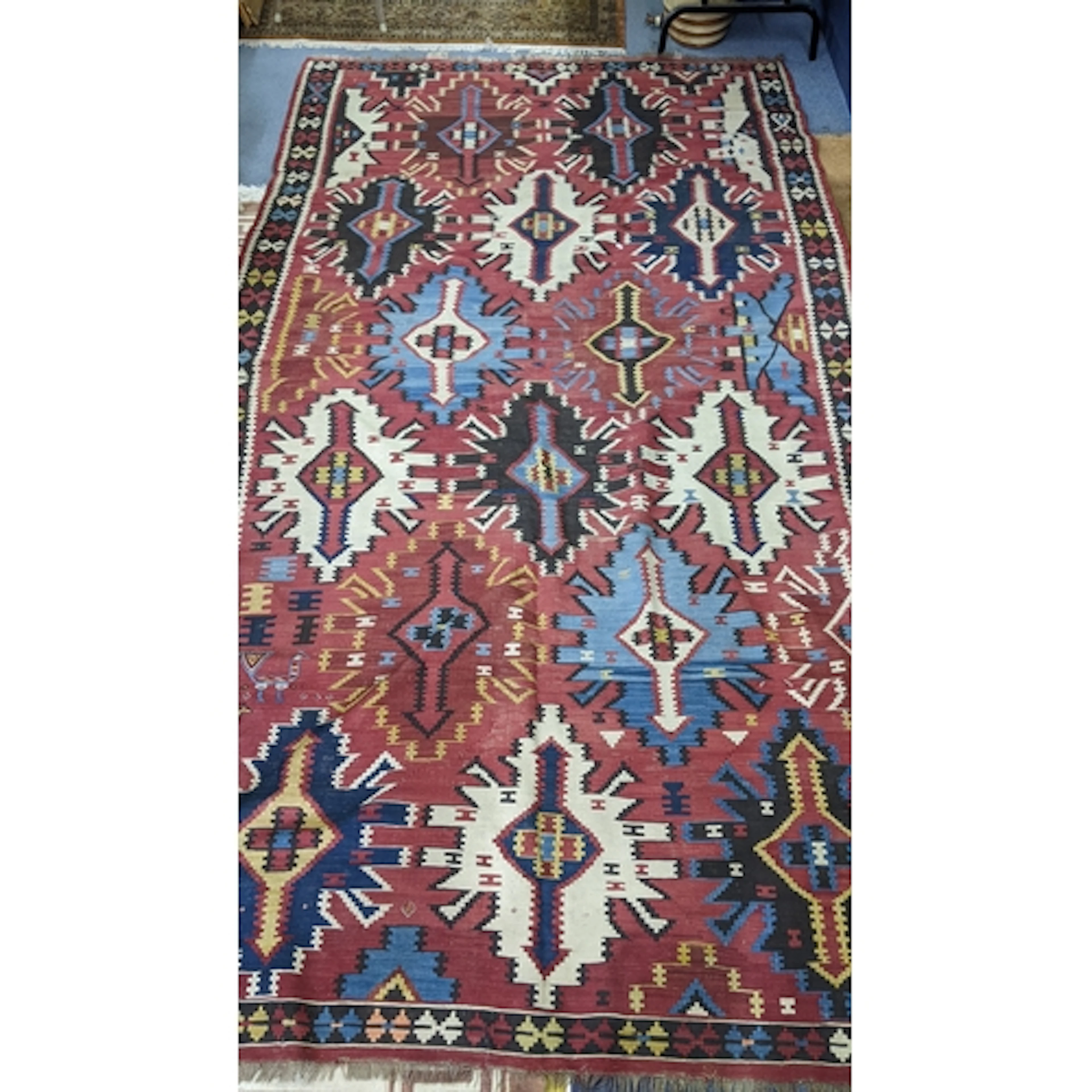 A Turkish handwoven rug having a red ground and decorated wi...
