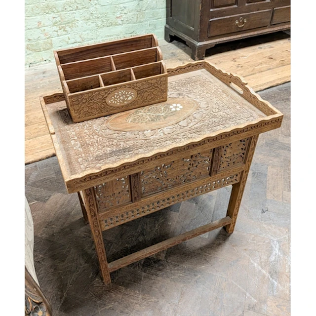 A Moorish style carved coffee table with folding stand and l...