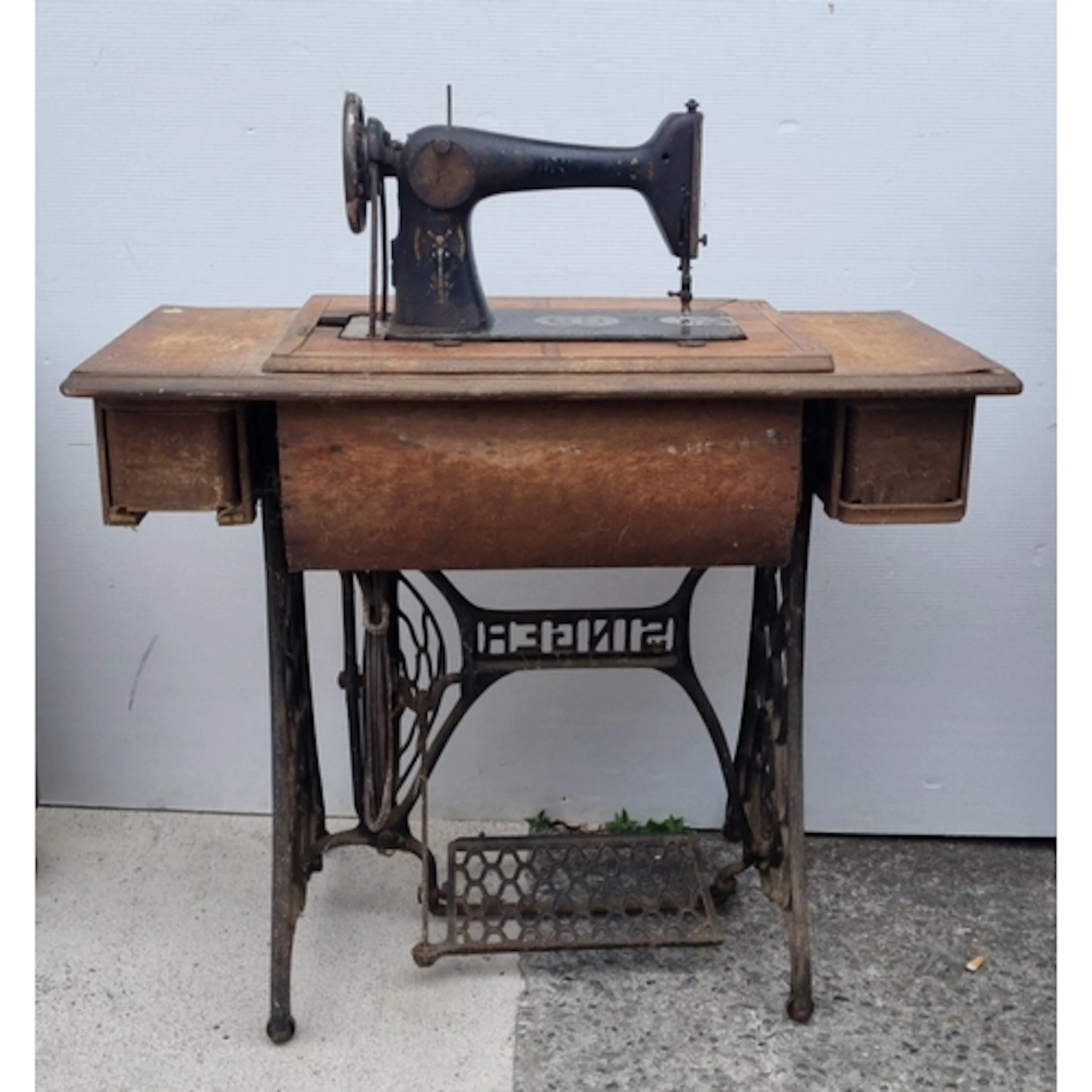 Singer treadle sewing machine in timber table with cast-iron...