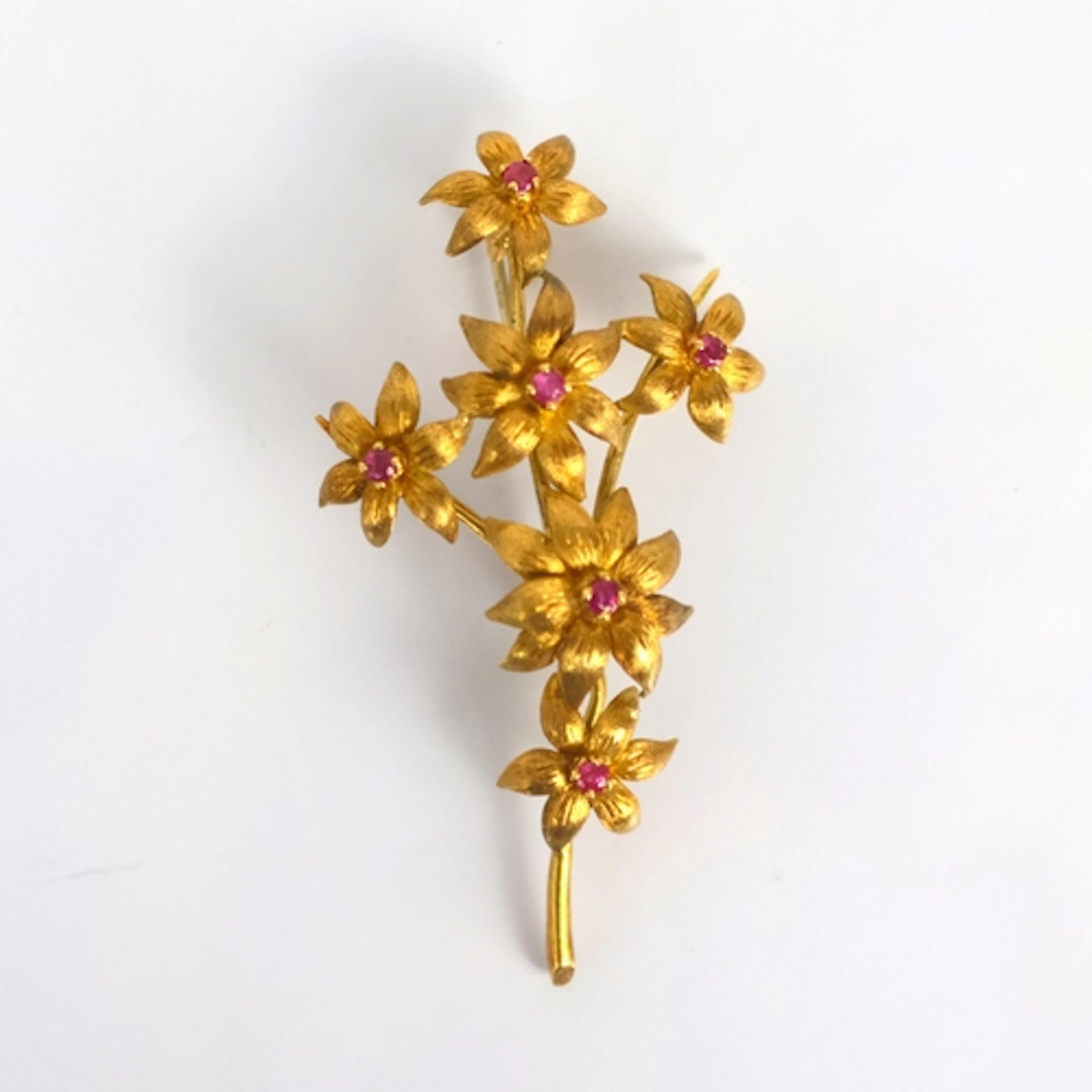 A late 20th century synthetic ruby spray brooch, modelled wi...