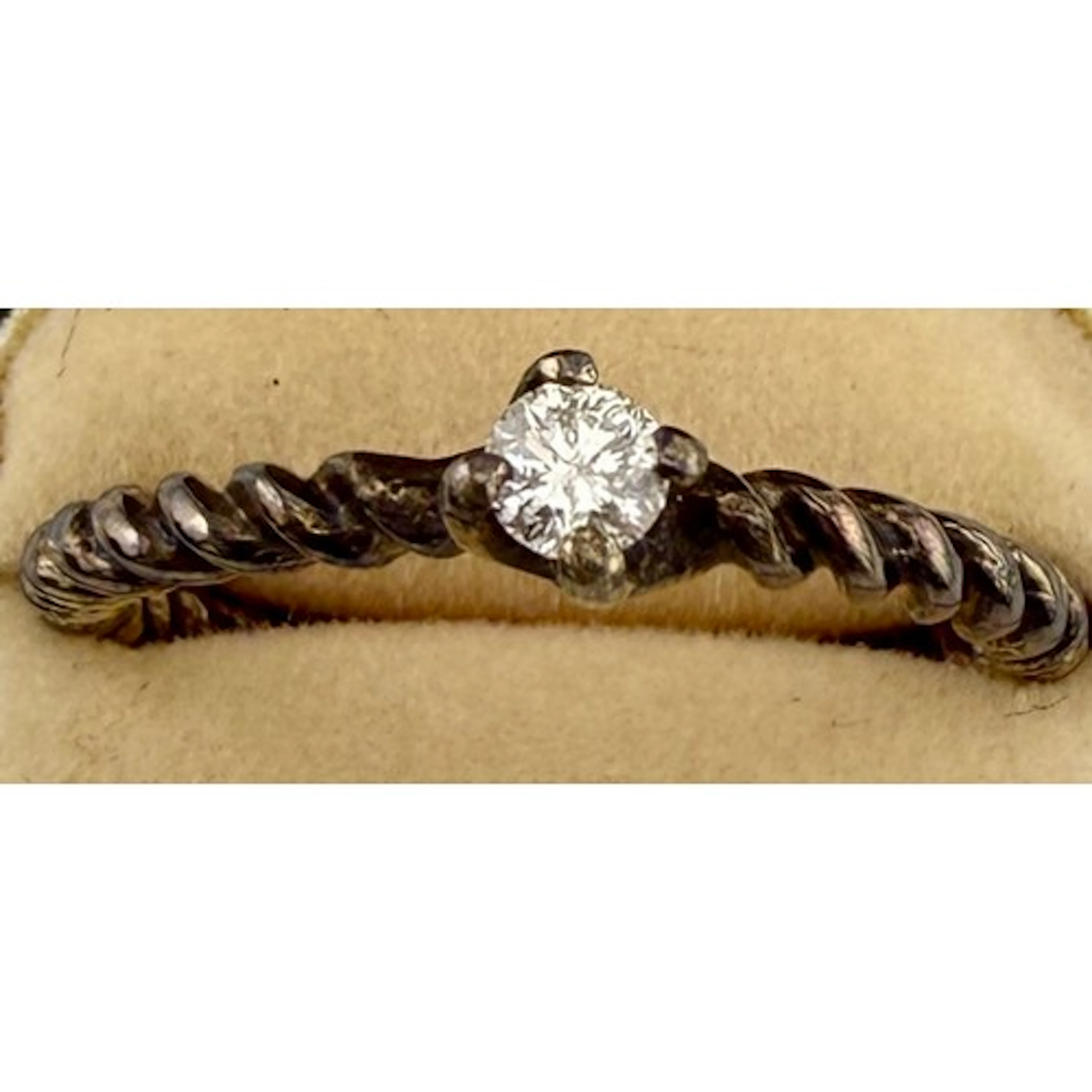 A solitaire diamond ring set in white metal, made by Belinda...