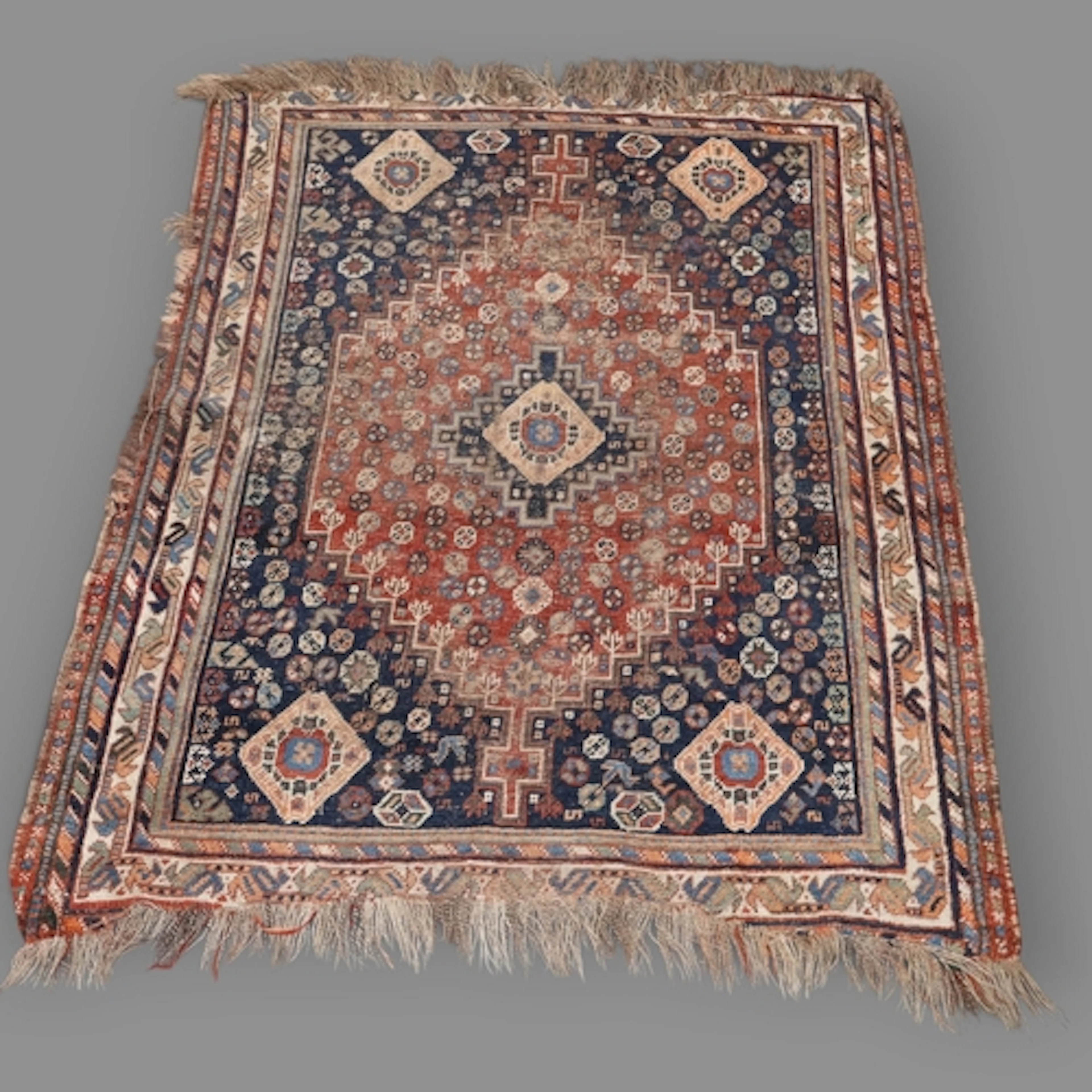A blue and red-ground Shiraz rug. L135cm, W111cm.