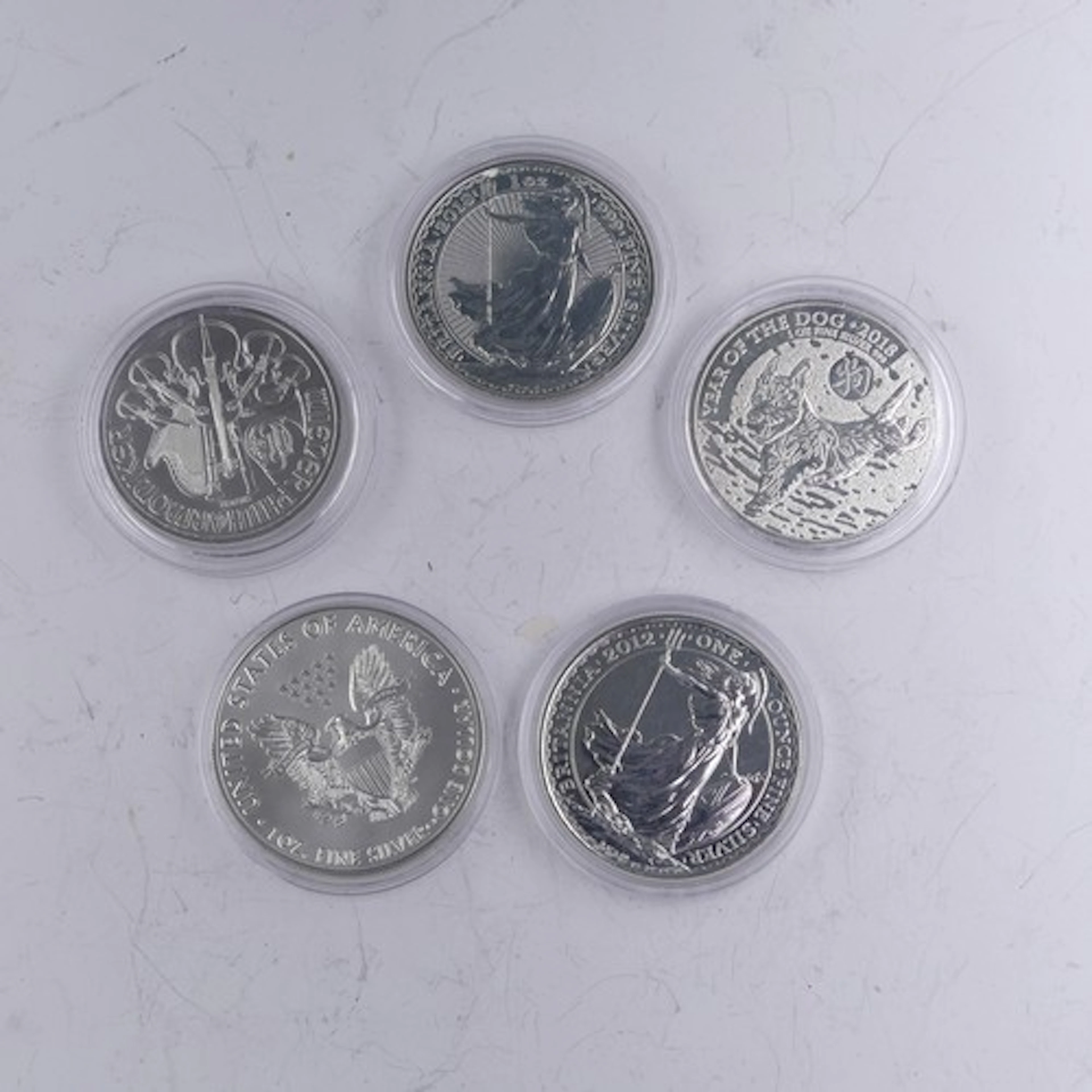 Two Britannia 1oz fine (.999) silver Coins, together with an...