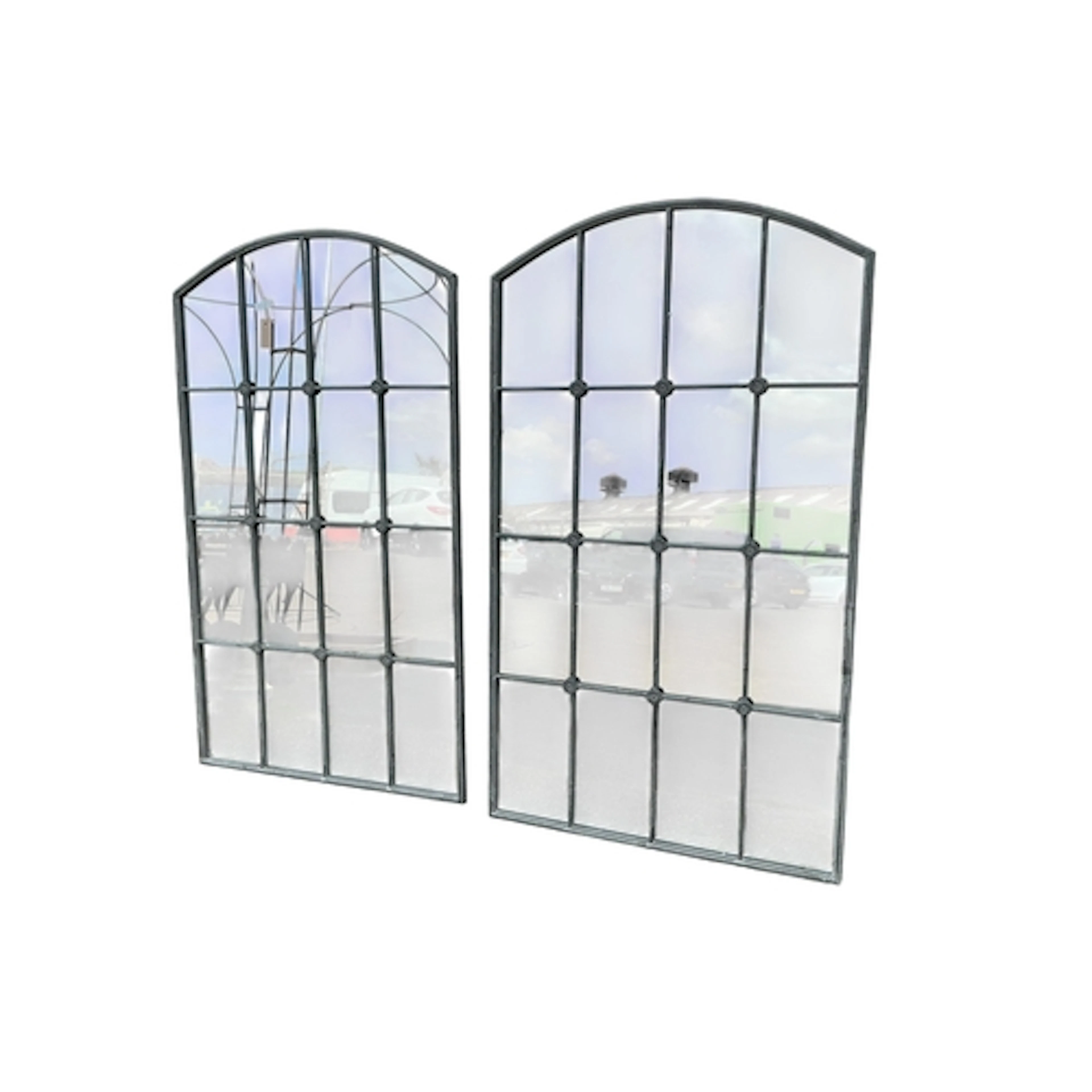 A pair of industrial style arched window frame mirrors, widt...