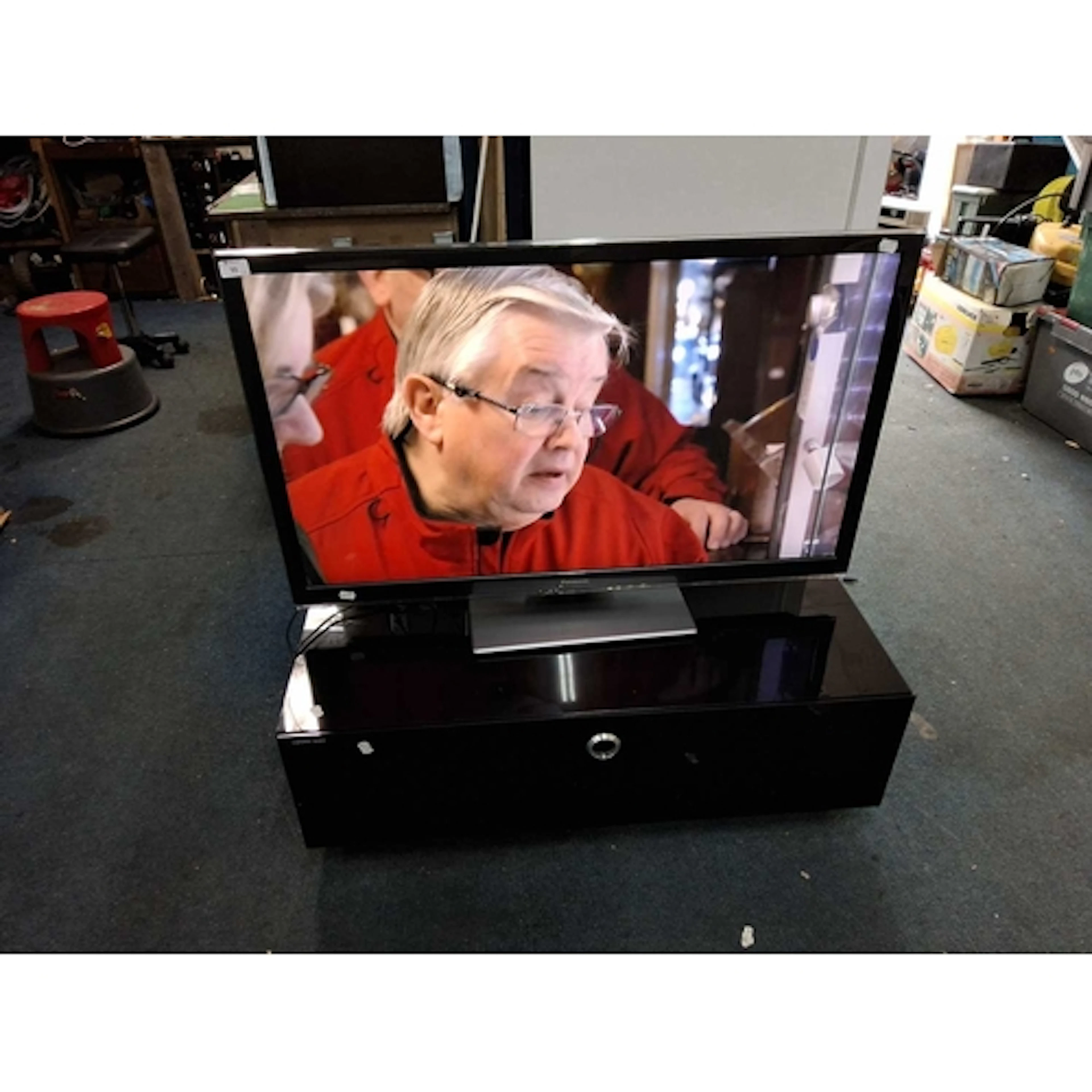 A PANASONIC TX-L42ET5B 42in TV without remote and a glass TV...