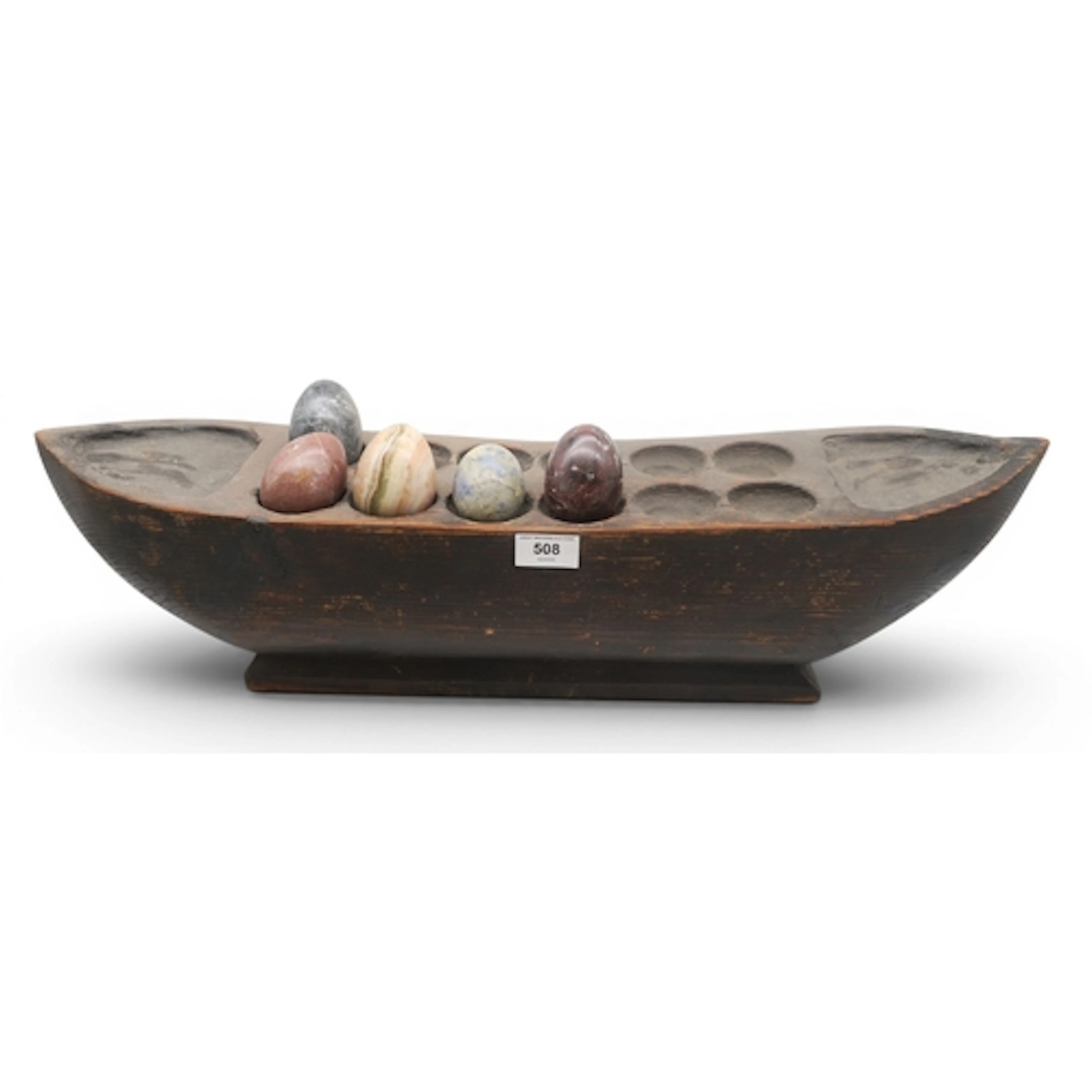 A large carved pine boat, housing five various hardstone egg...