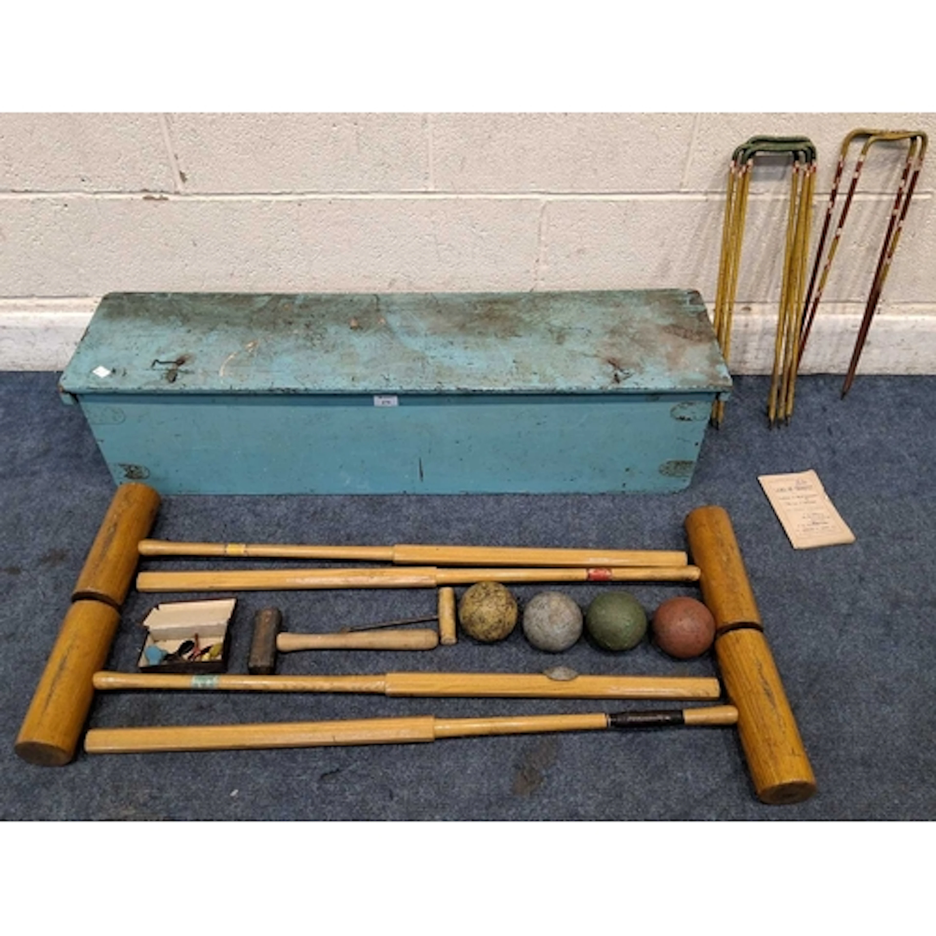 A BLUE PAINTED CRATE, containing four wooden mallets, four b...