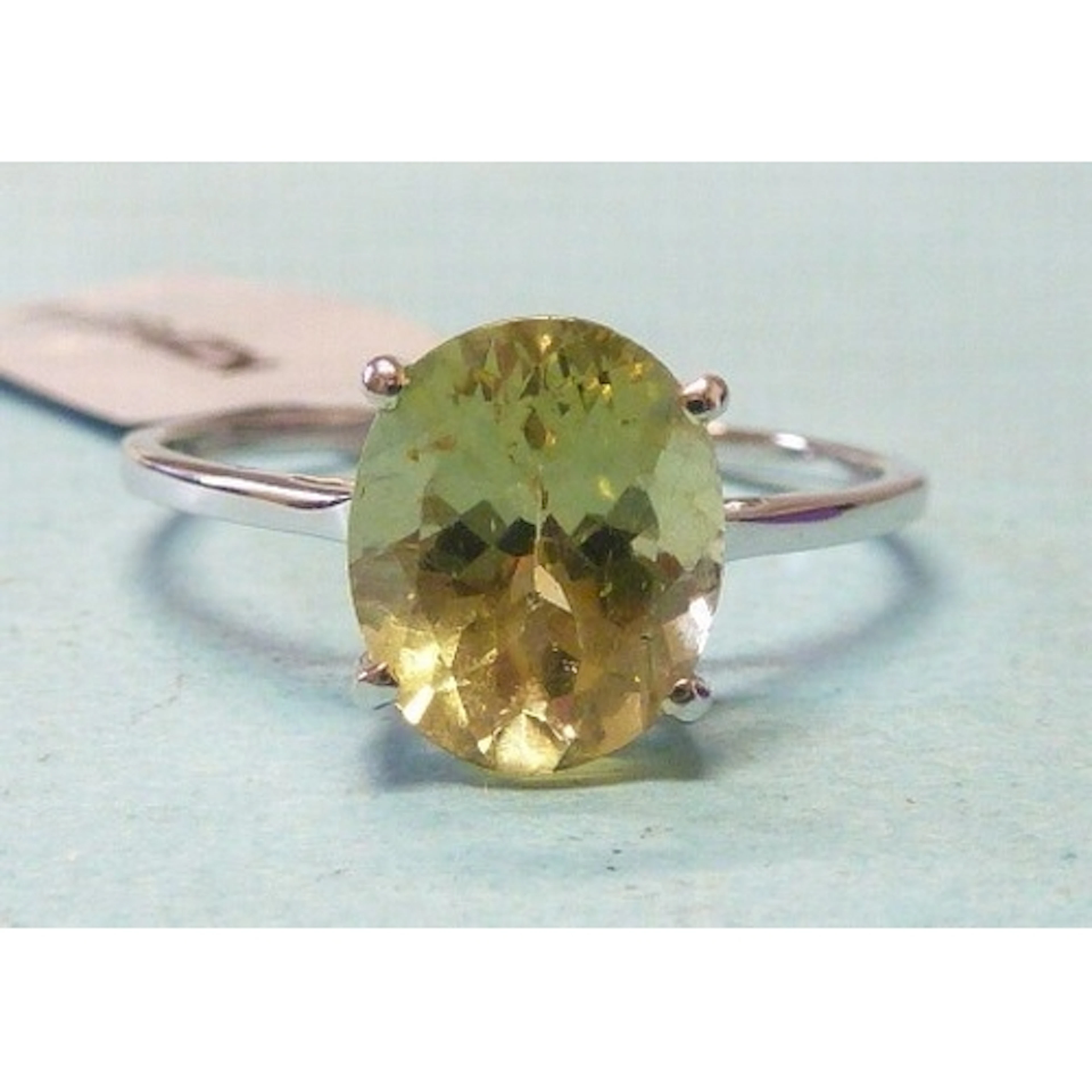 Gemporia, a 9k white gold solitaire ring set an oval apatite...