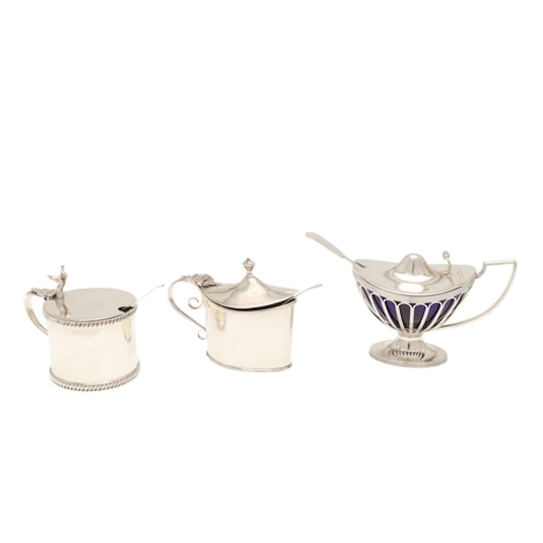 THREE SILVER MUSTARD POTS. To include an Edwardian Silver Ov...
