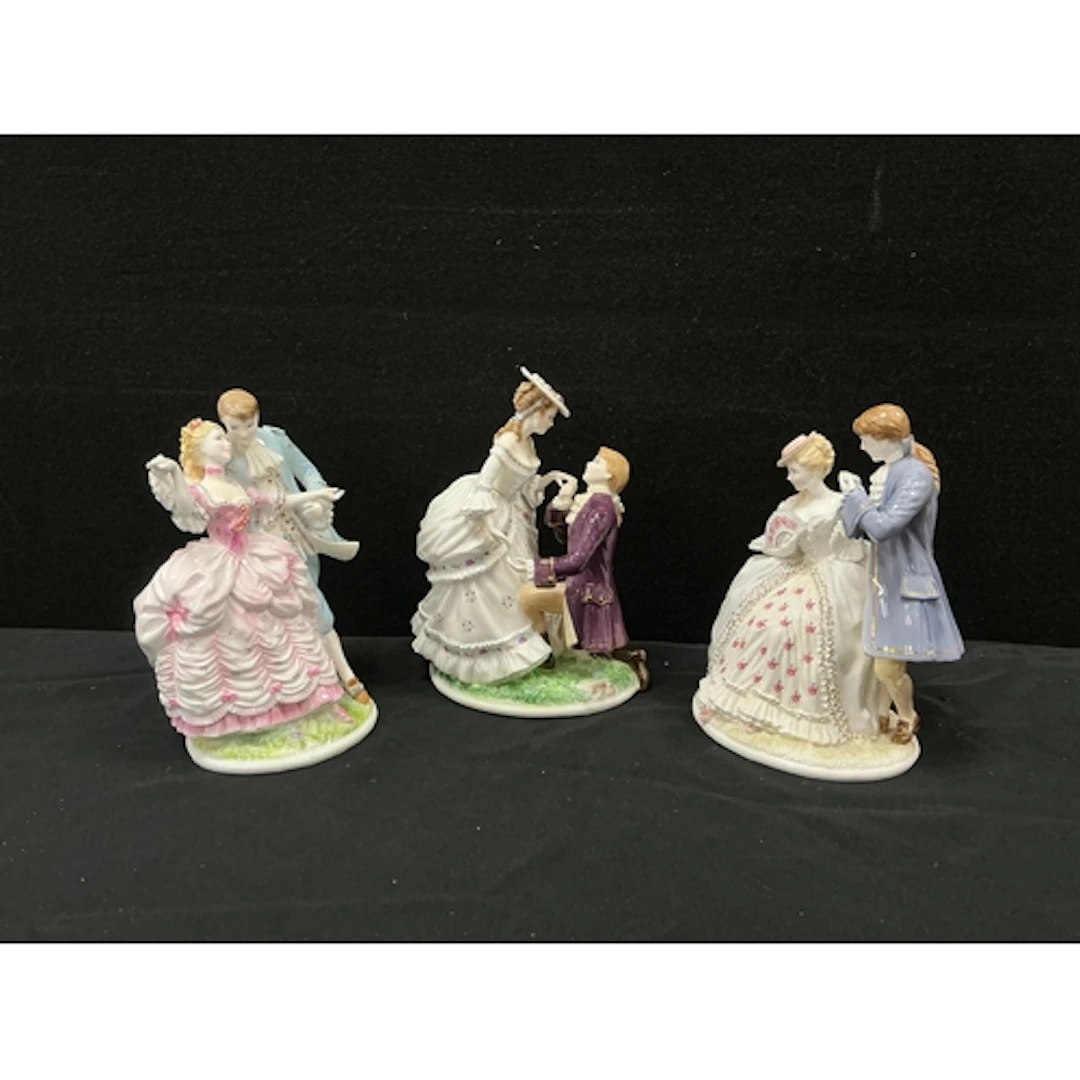 Royal Worcester figurine ‘ The Tryst’, a lady sits upon a wa...