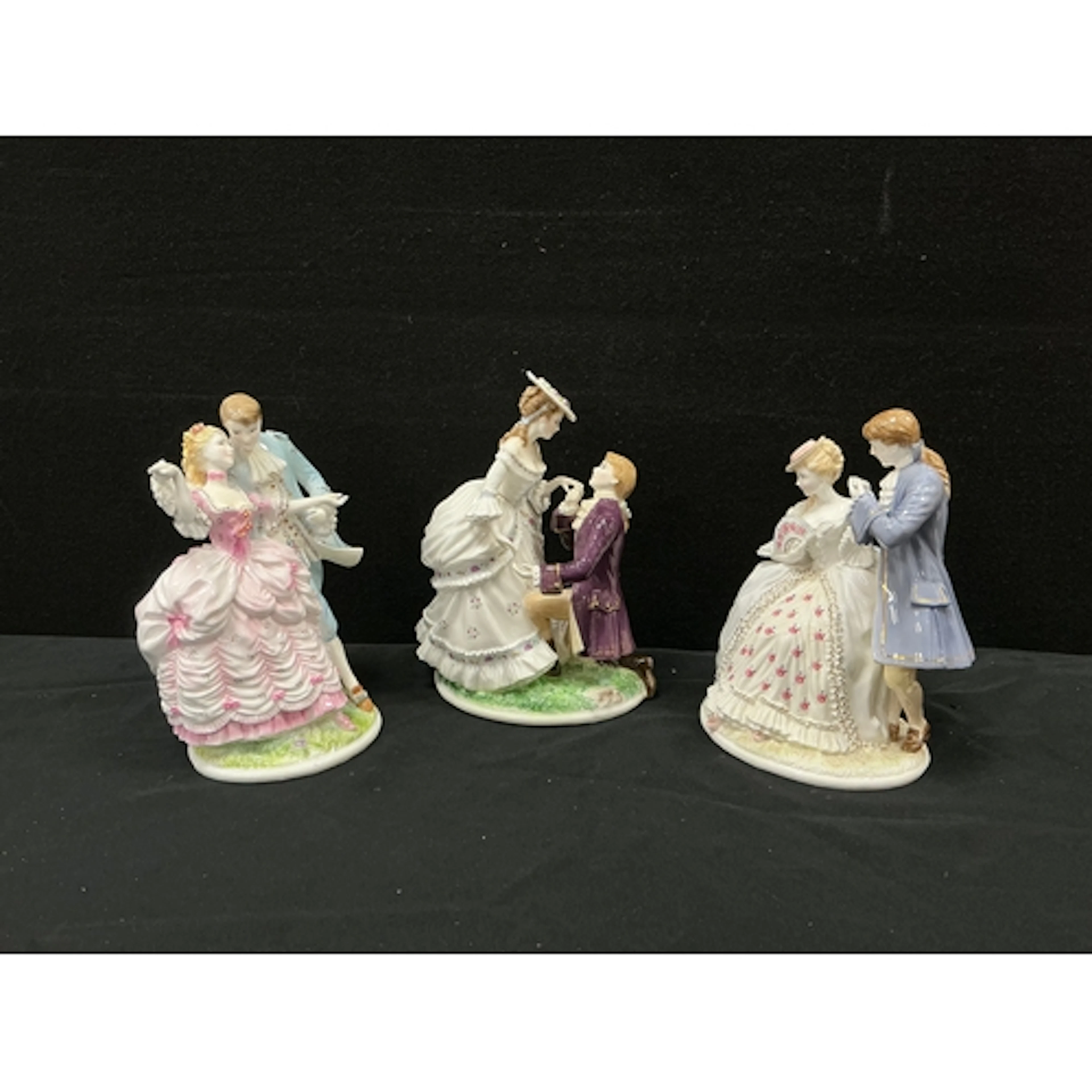 Royal Worcester figurine ‘ The Tryst’, a lady sits upon a wa...
