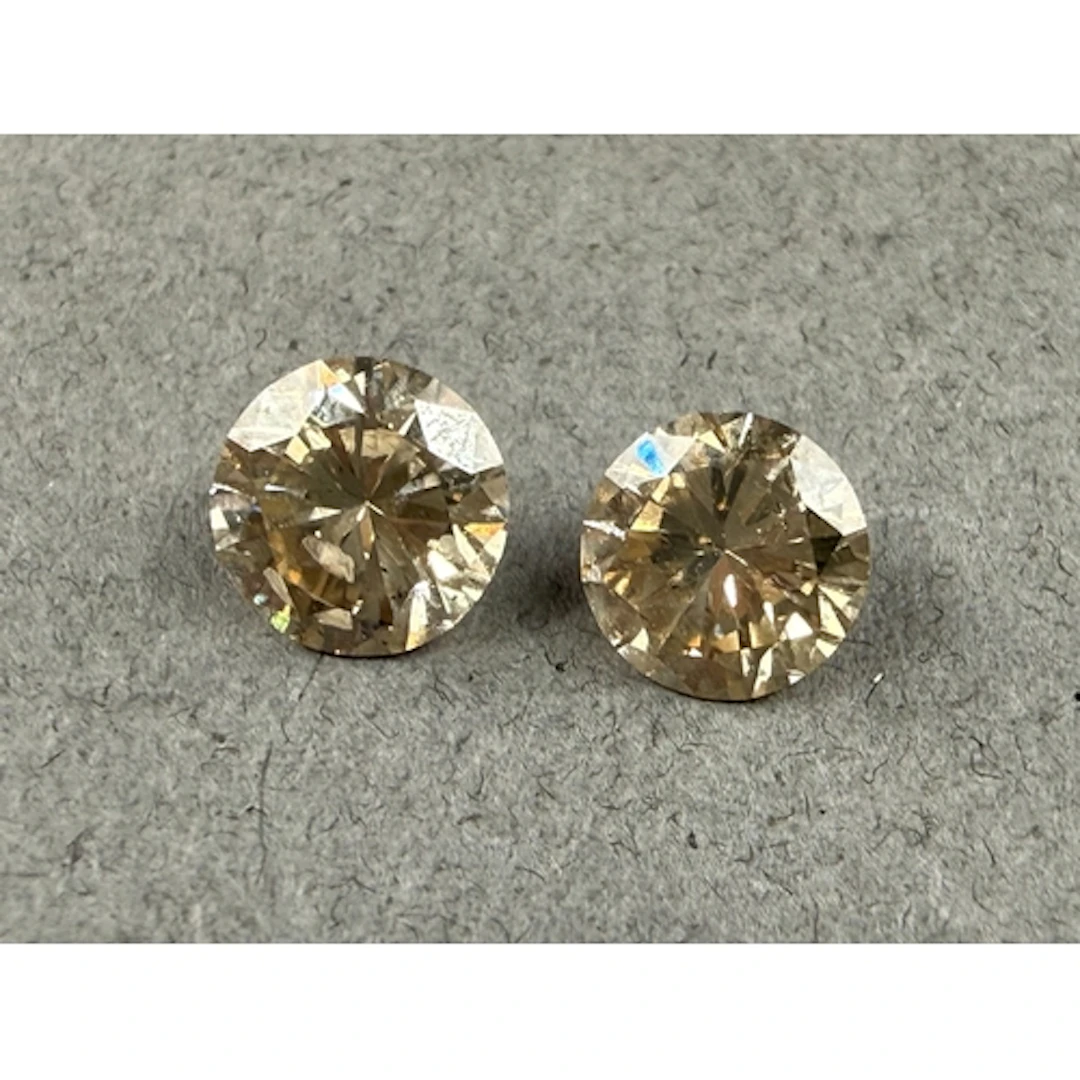 V Jewellery: a pair of loose fancy brown brilliant cut diam...