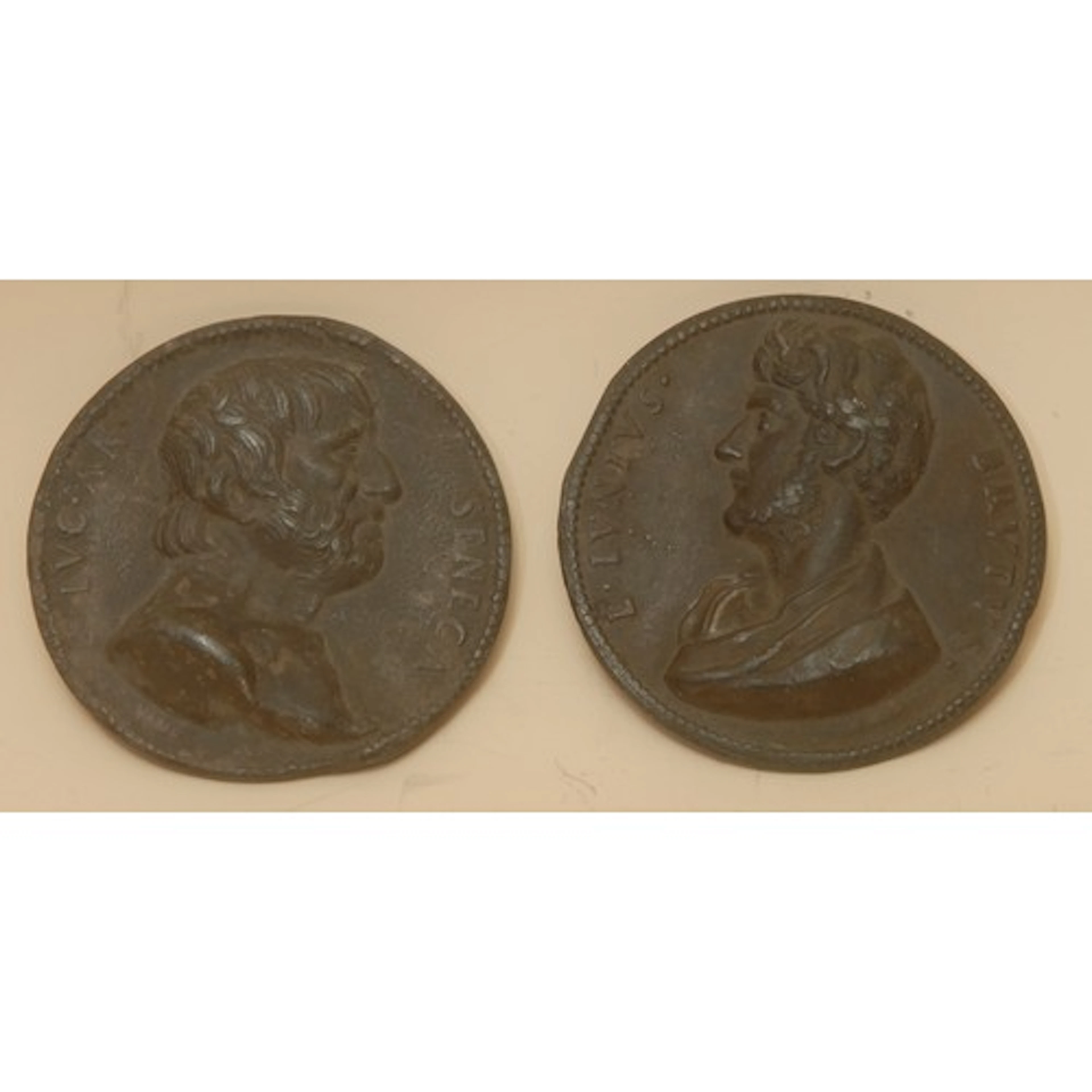 A pair of 18th century Neo-classical lead medallions, cast w...