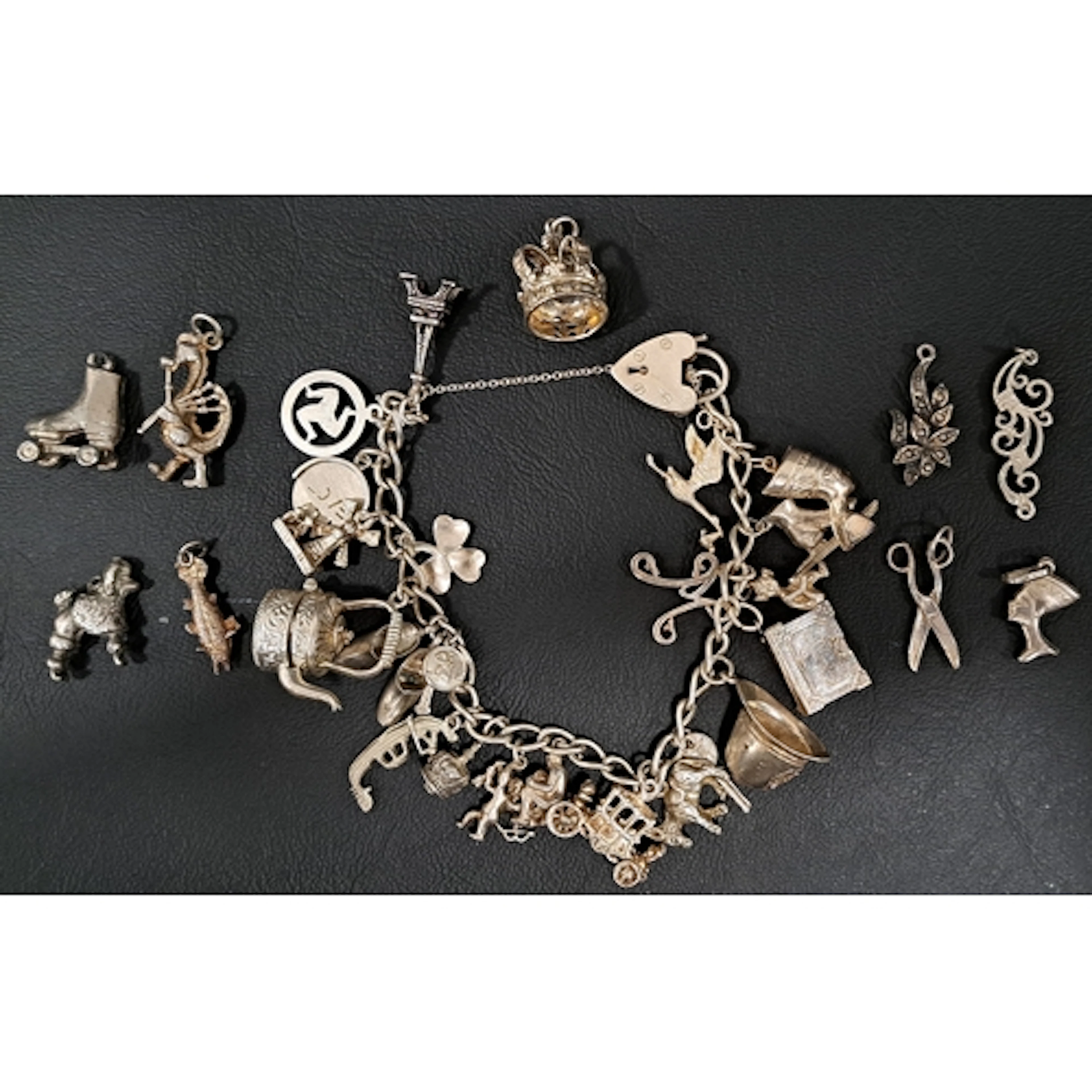 SILVER CHARM BRACELET with heart padlock clasp and a good se...