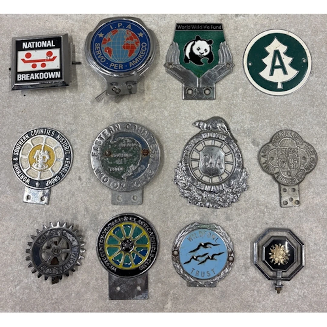 A collection of twelve car badges. Est. £20 - £30.