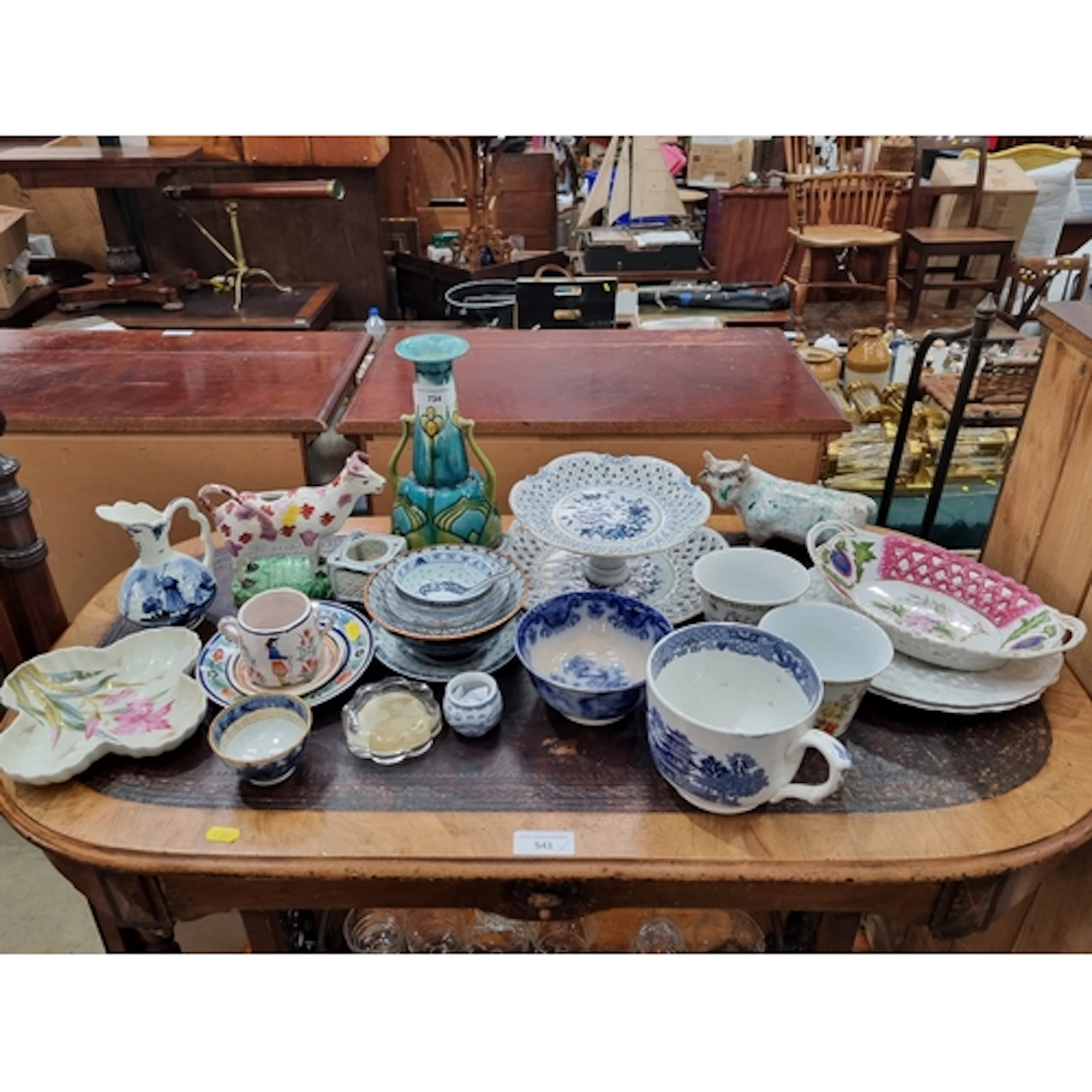 A collection of ceramics including Staffordshire Cow Creamer...