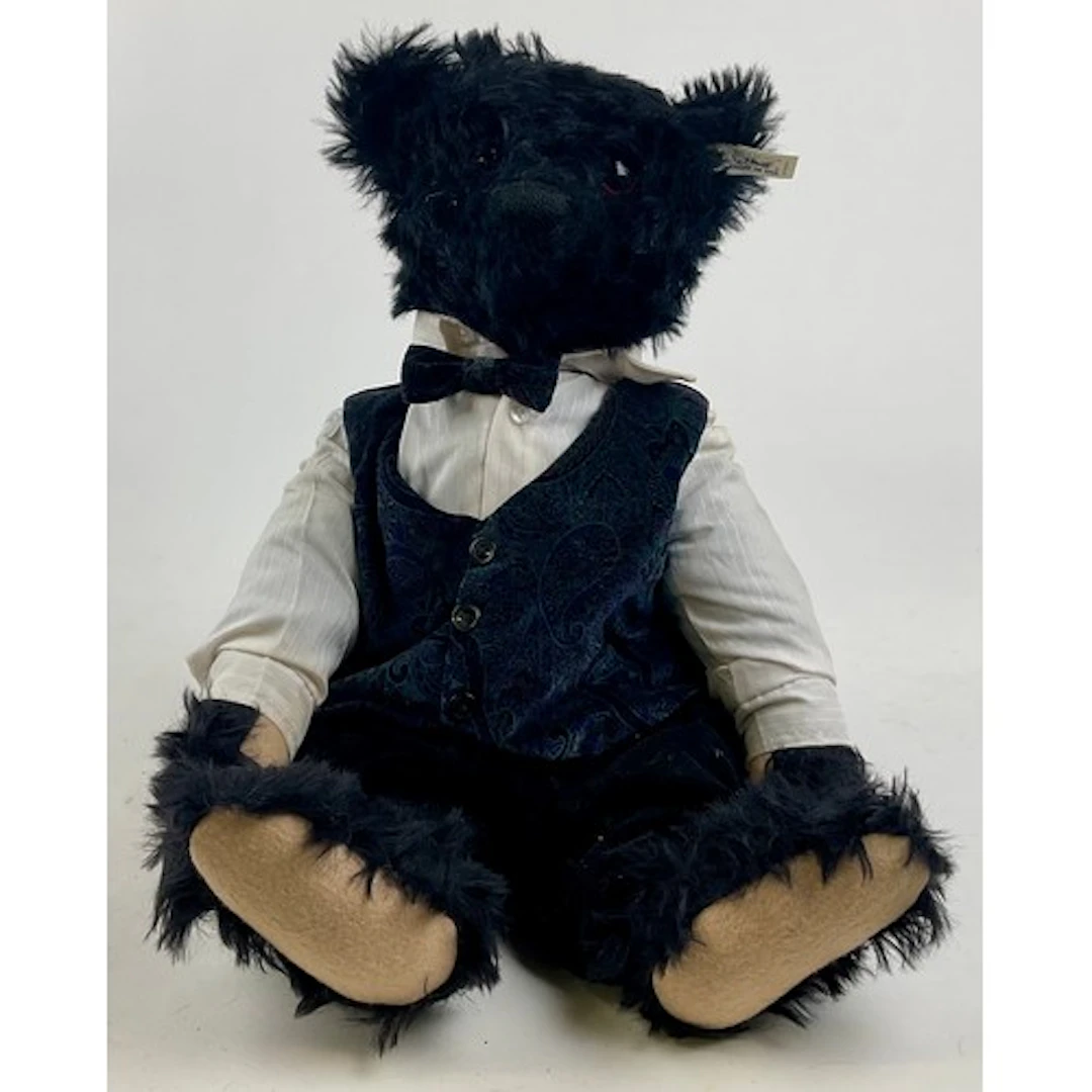A 1991 Steiff black mohair bear, deep amber and black eyes, ...
