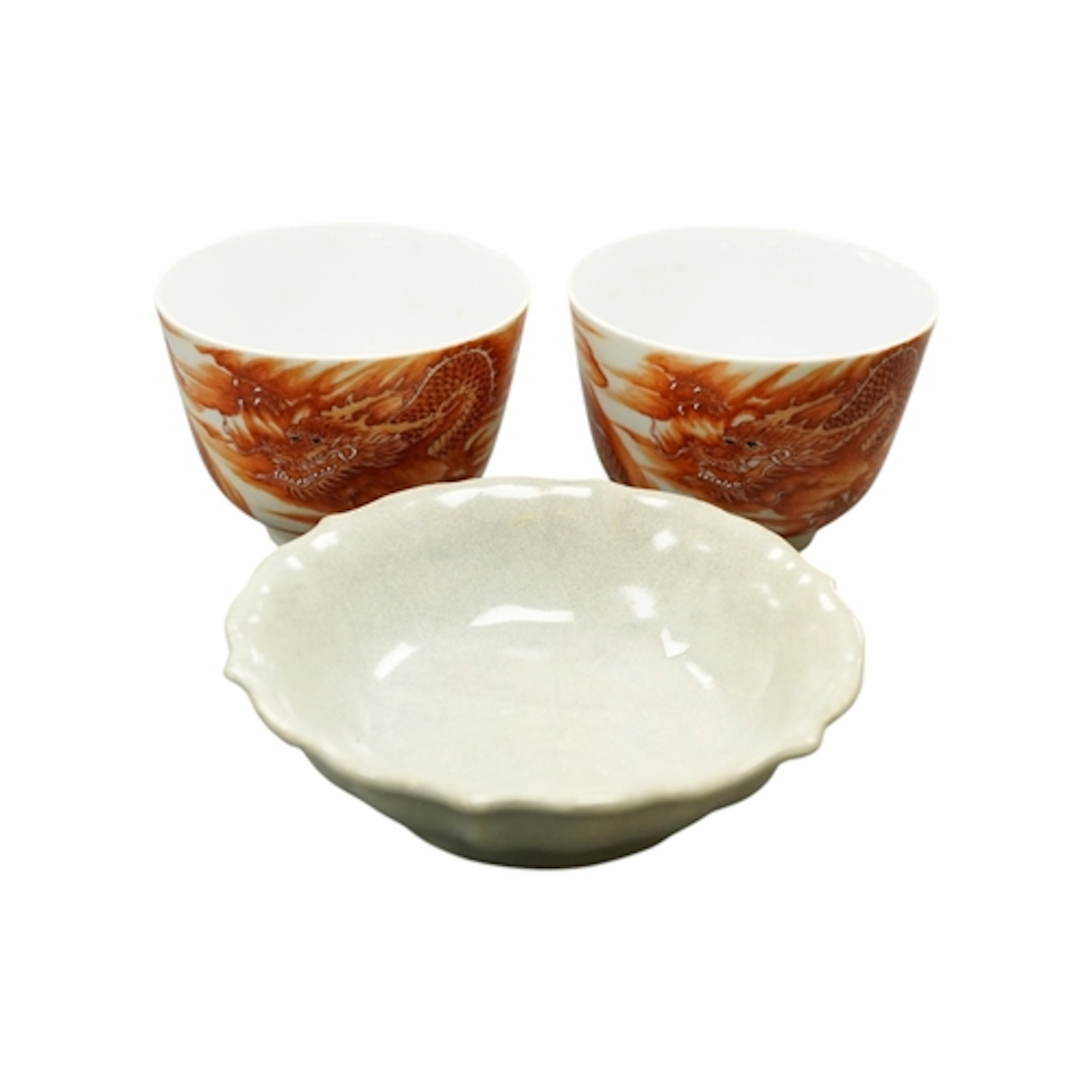 A pair of Chinese copper-red 'dragon' cups and a lobed crack...