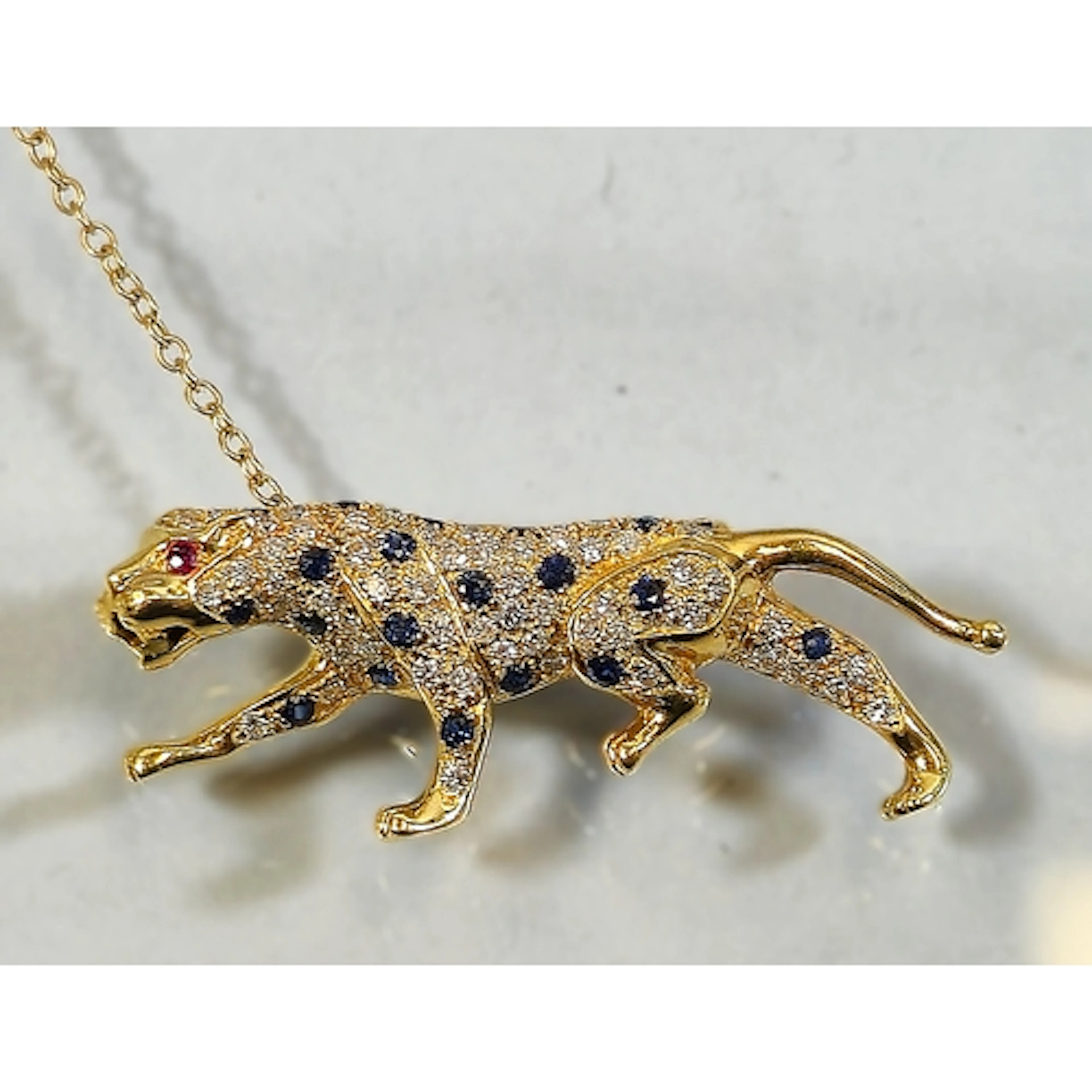 15ct gold sapphire, diamond and ruby leopard brooch, set wit...