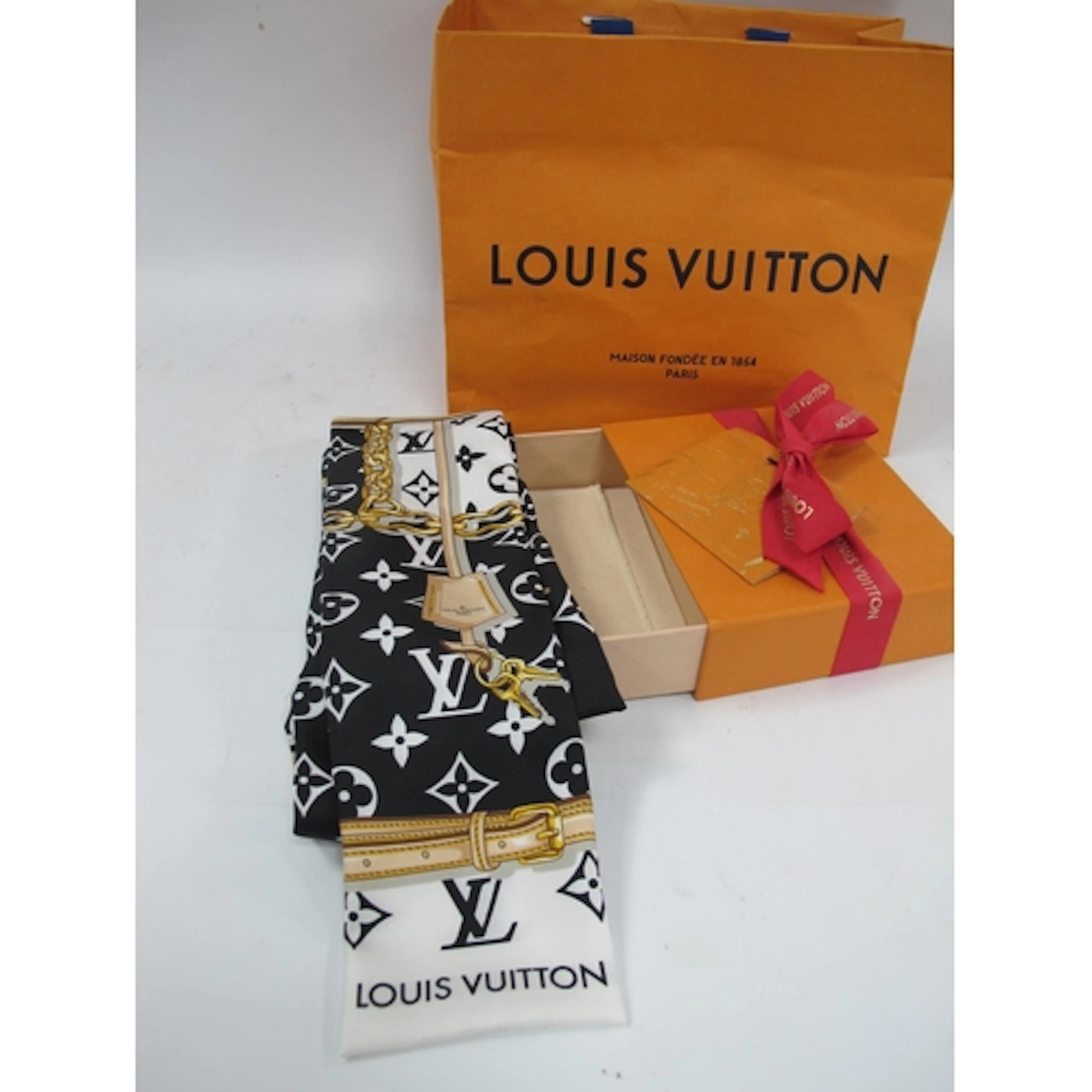 Louis Vuitton; A LV Monogram Confidential Silk Bandeau Scarf...