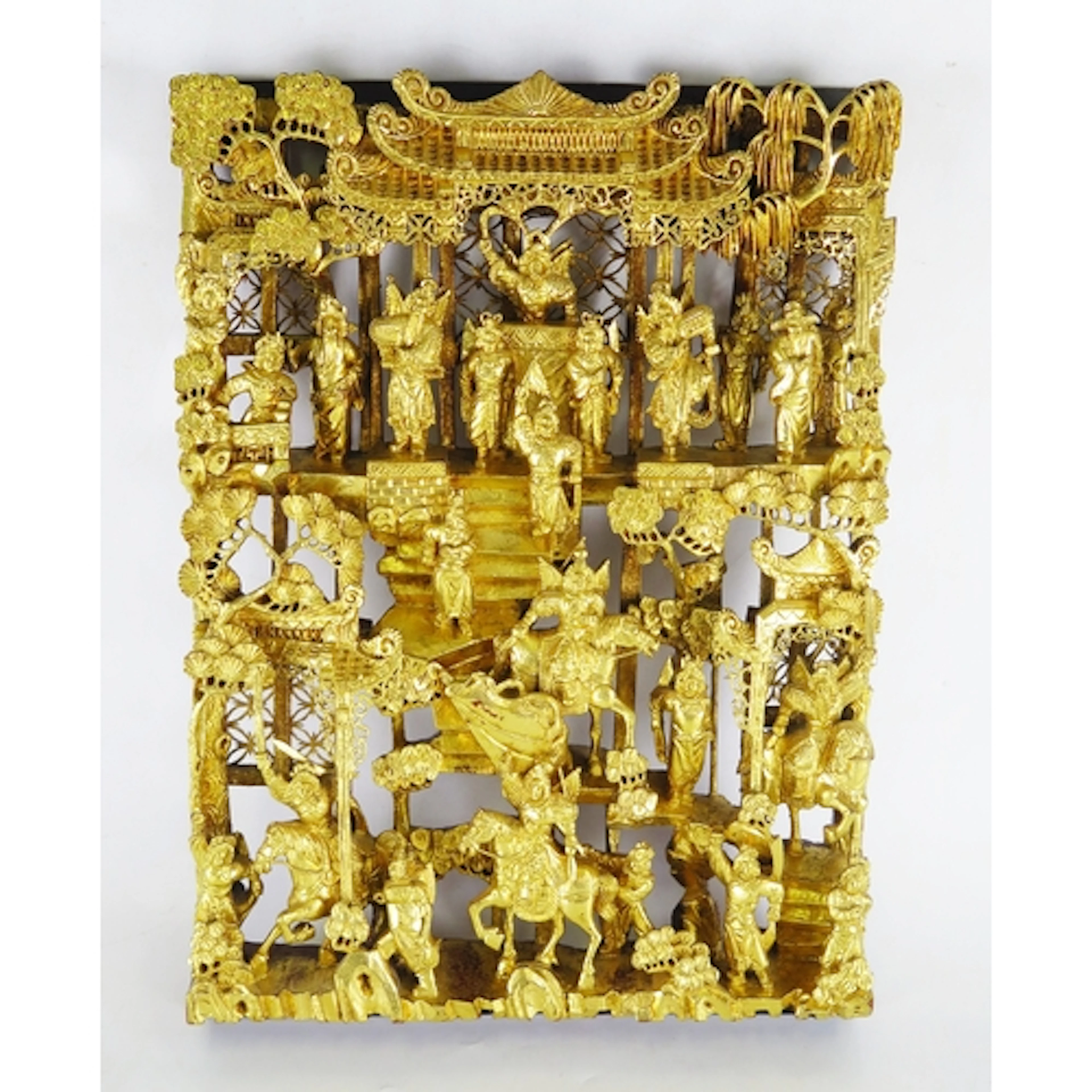 A Chinese carved giltwood panel depicting mounted warriors a...