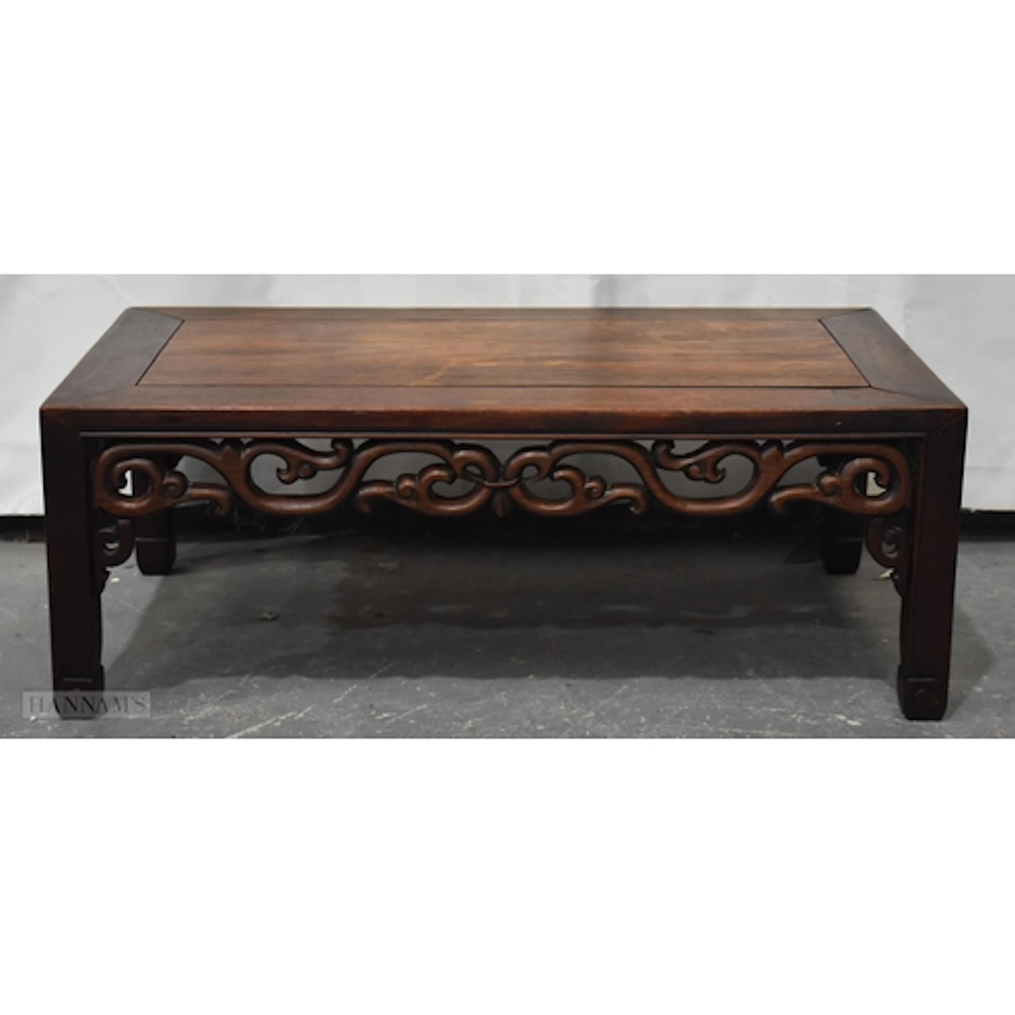 A 19TH CENTURY CHINESE CARVED HUANGHUALI WOOD LOW TABLE Qing...