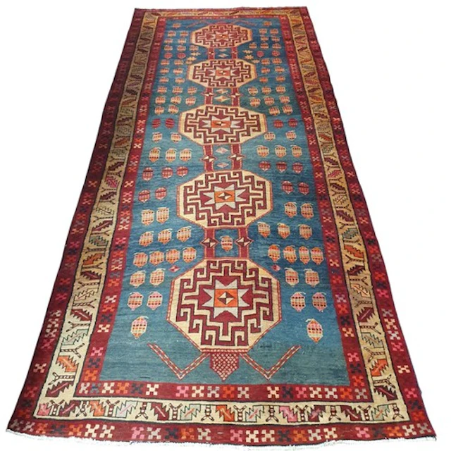 A Persian Runner with red ground with multi borders and cent...