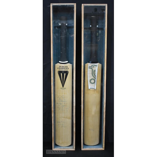 Two cased and Autographed cricket bats one England V West I...