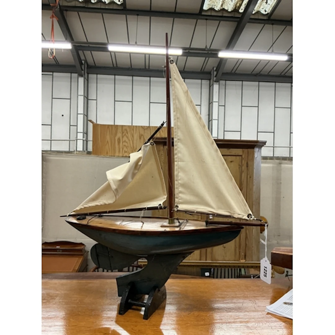 A small 1930's pond yacht, two cotton sails, partially repai...