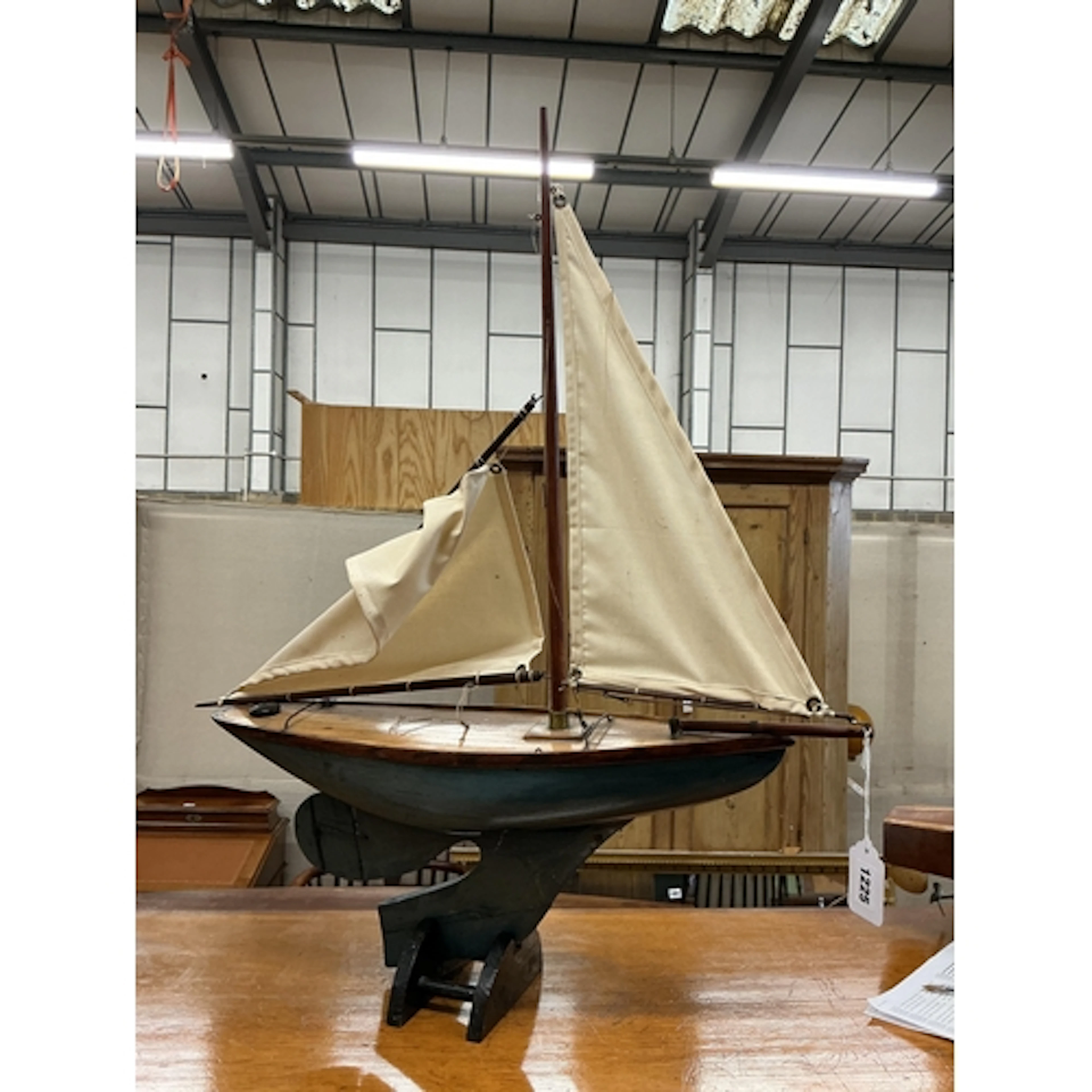 A small 1930's pond yacht, two cotton sails, partially repai...