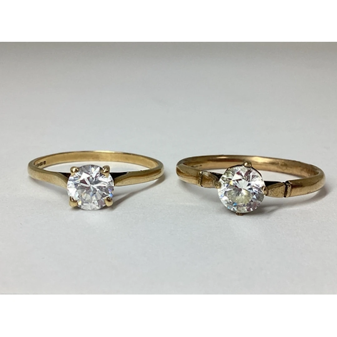 A 9ct Gold Single Stone Ring, four claw set, between plain t...